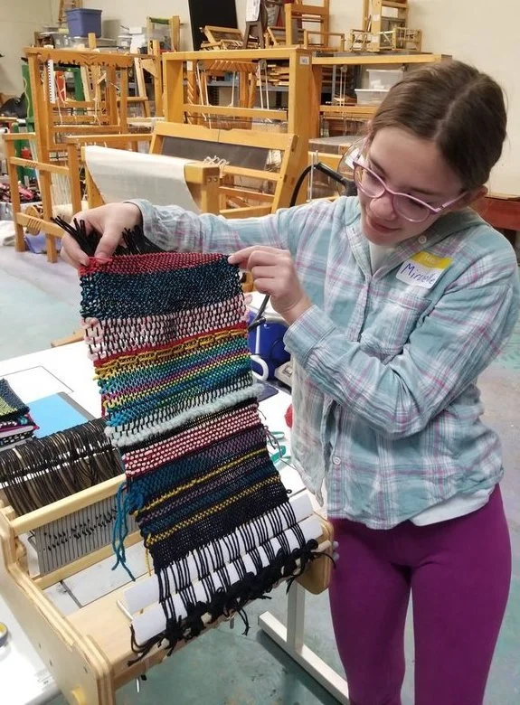 Mirabelle taking weaving off loom.jpeg