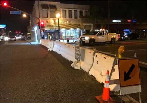 Compton K-Rail for event parking being set up on the street.