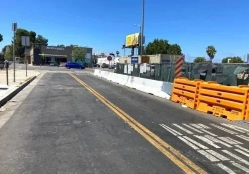 Whittier k-rail barriers on the perimeter of a commercial construction site.
