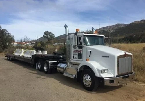 An Ellis Equipment truck going to deliver barriers for commercial property protection near Seal Beach, California.