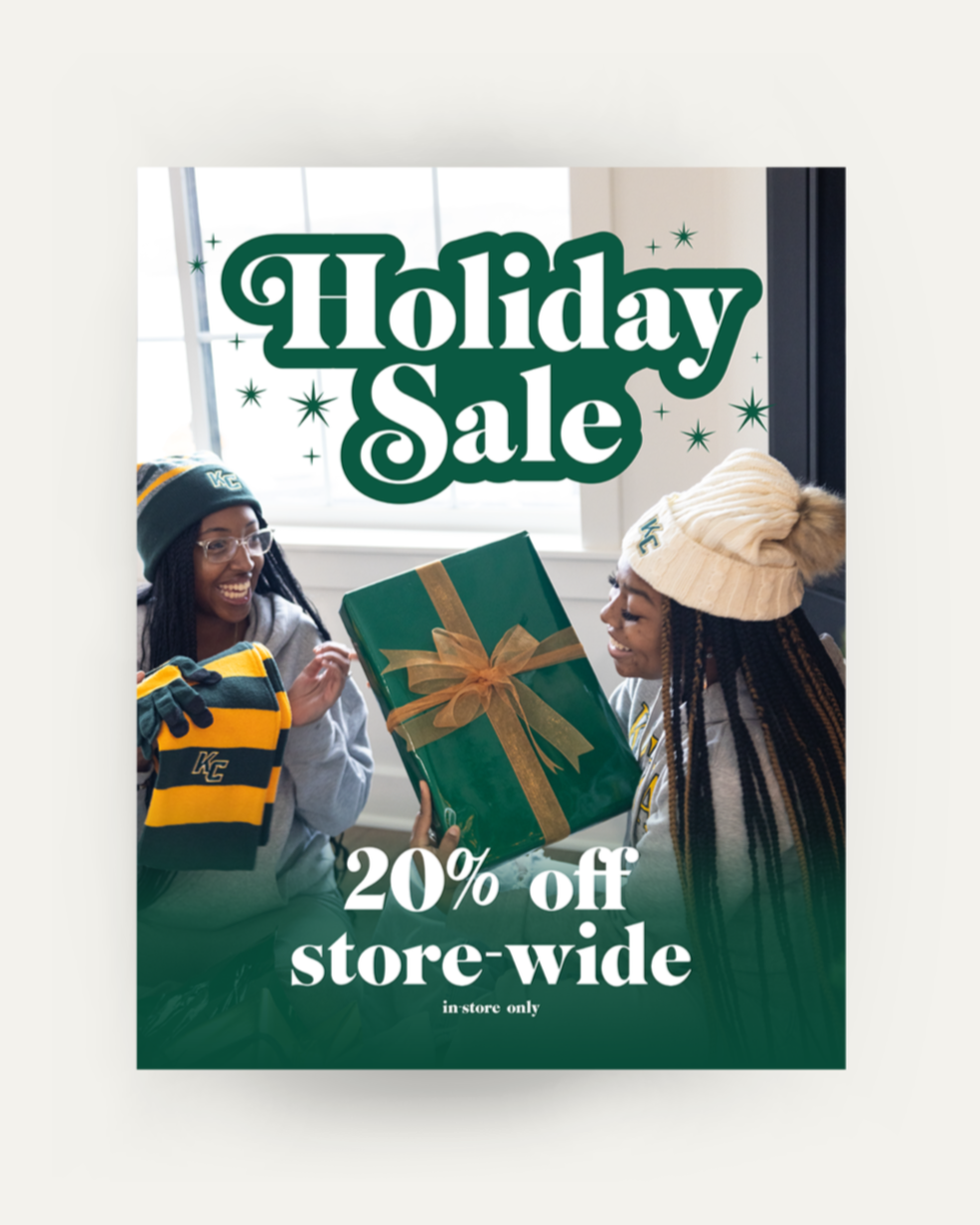 Poster advertising the holiday sale of 20% off store-wide, in-store only, sale ends January 1st 2026. It shows 2 girls dressed in Keuka College hats and sweatshirts, opening a gift box with scarves and gloves.