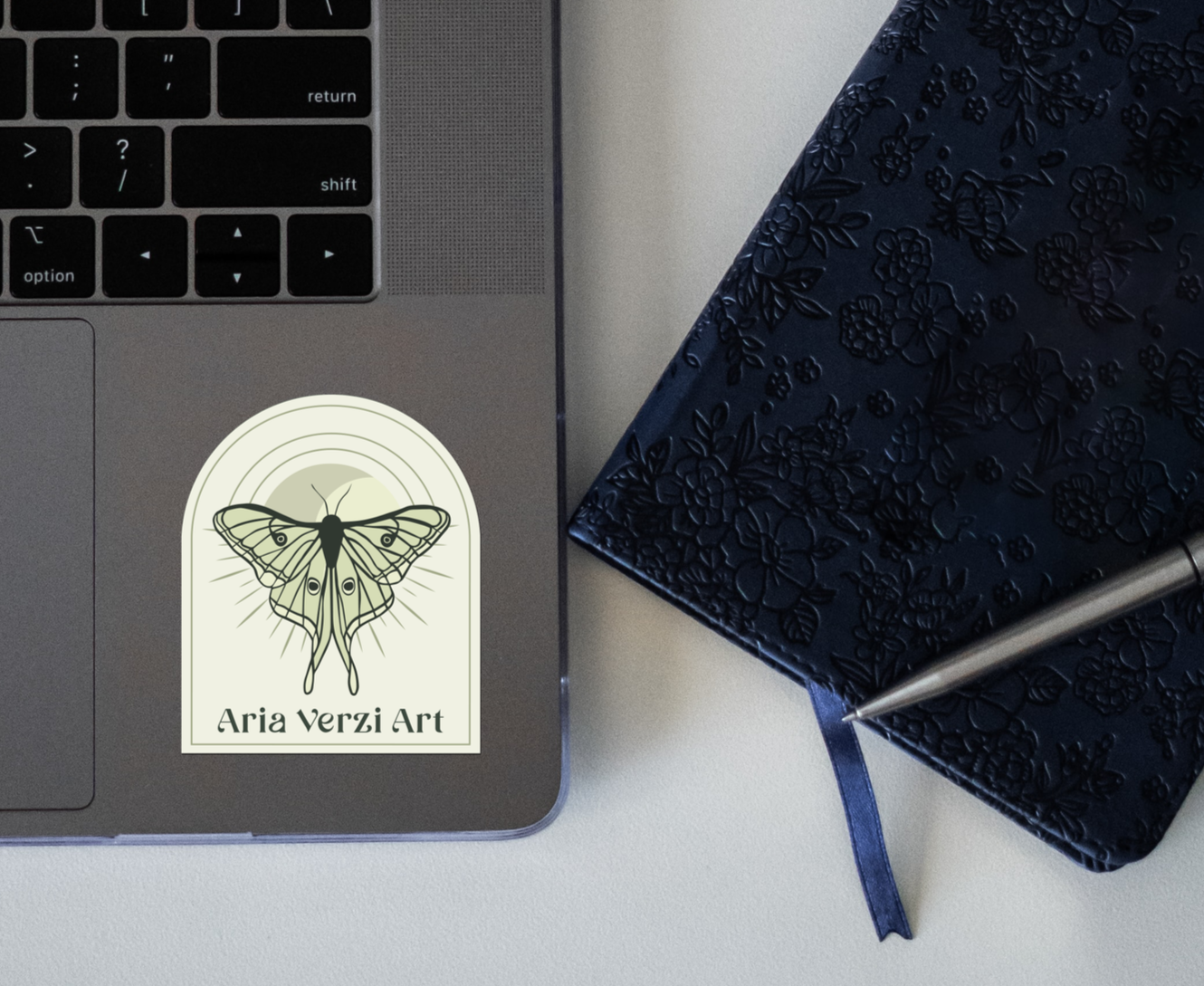 Aria Verzi Art logo sticker on a latop.