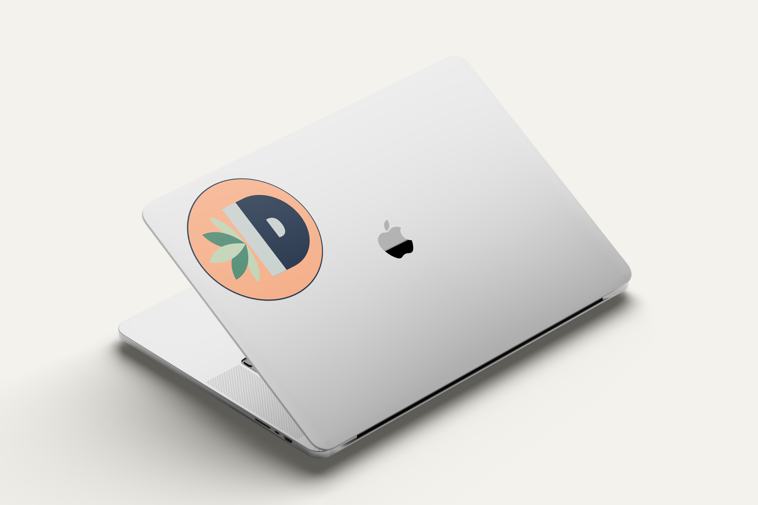 A laptop with an Indoor Dirt sticker of the logo symbol.