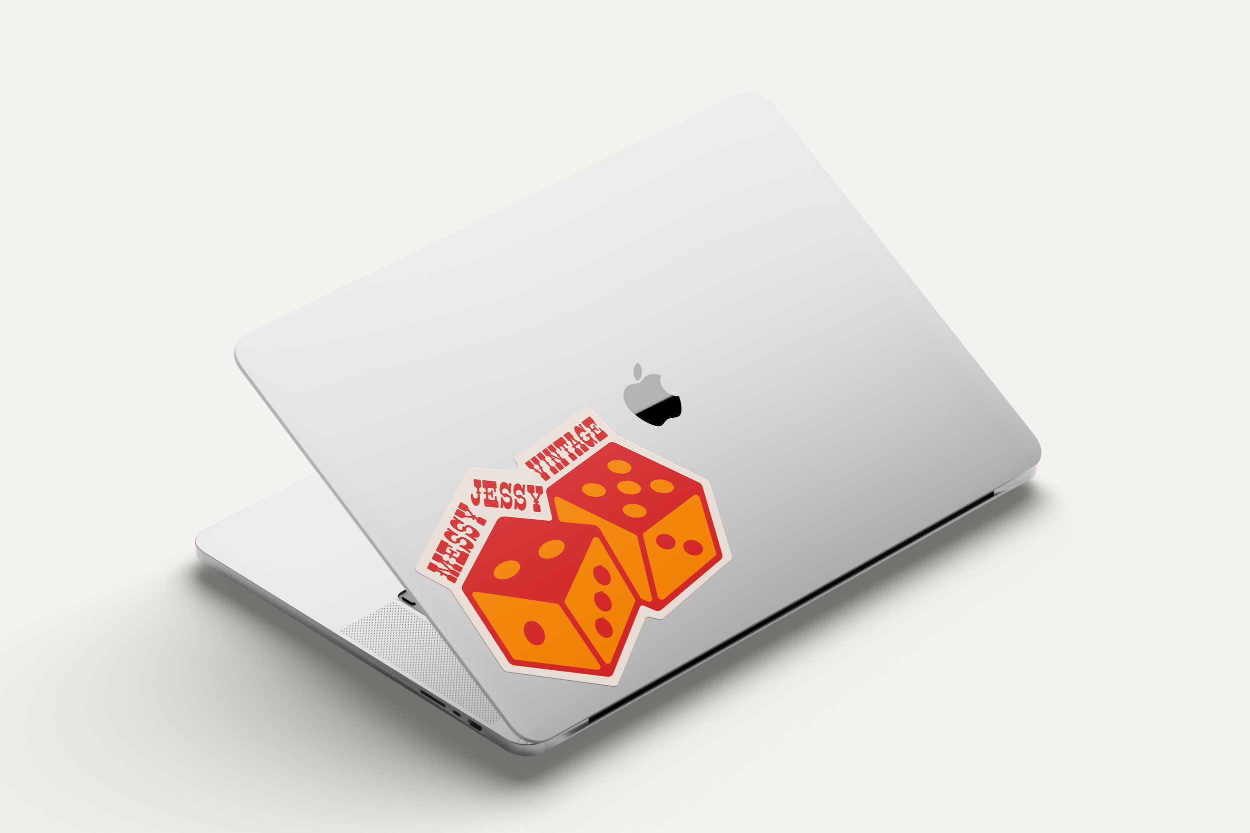 Messy Jessy Vintage rebrand supporting element dice illustration as a sticker on a laptop.