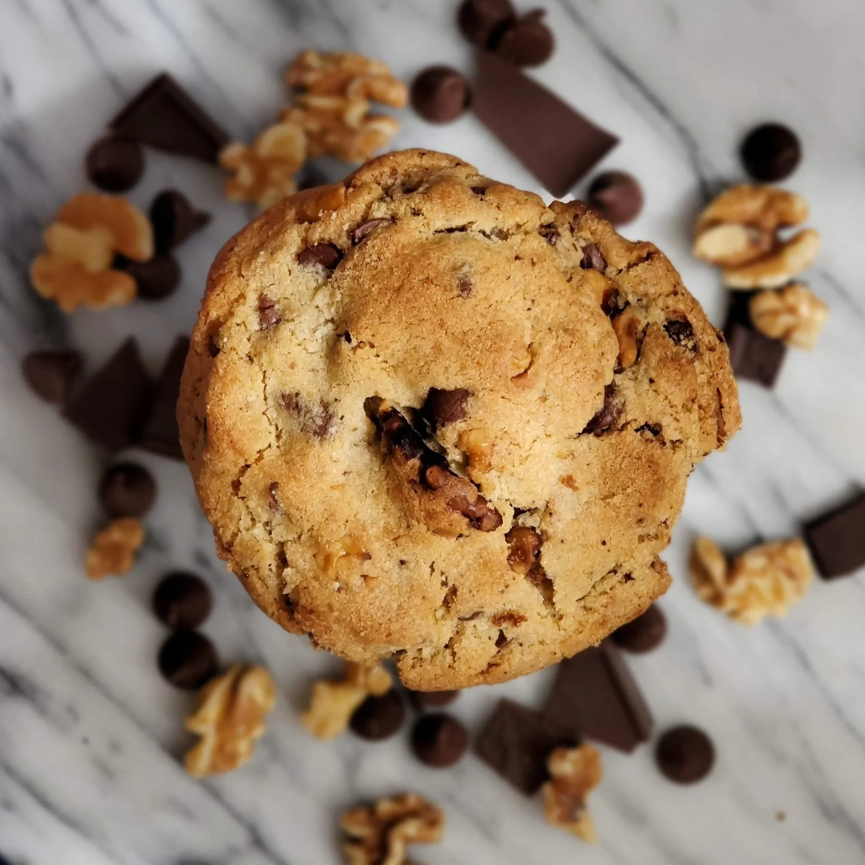 cookie with roasted walnuts and chocolate on a marble background