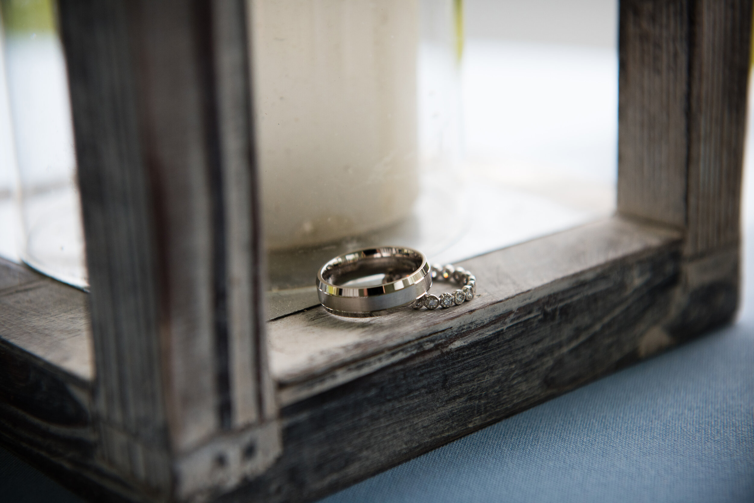 Seaside cape cod microwedding, rings sitting on edge of latern