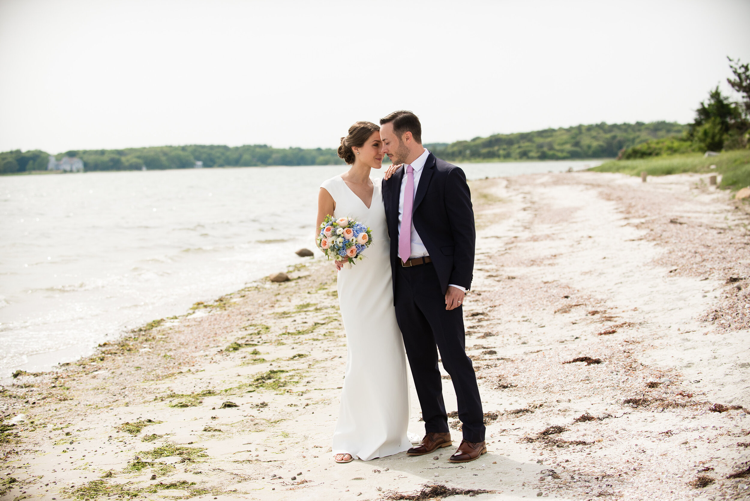 Seaside cape cod microwedding, bride and groom take photos on beach