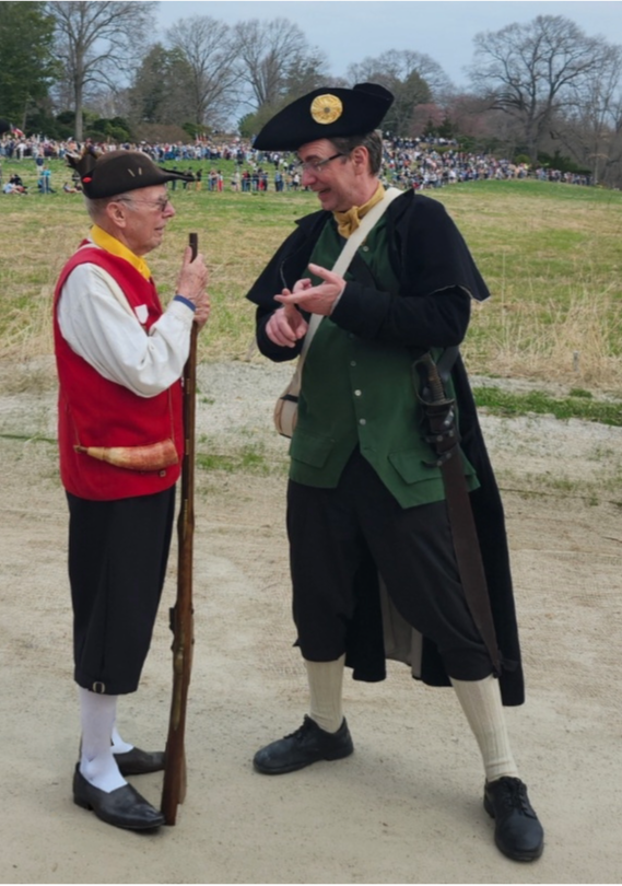 1975 Captain Gerry Gaebel and 2025 Captain Chad Childers discuss strategy before crossing the North Bridge in Concord