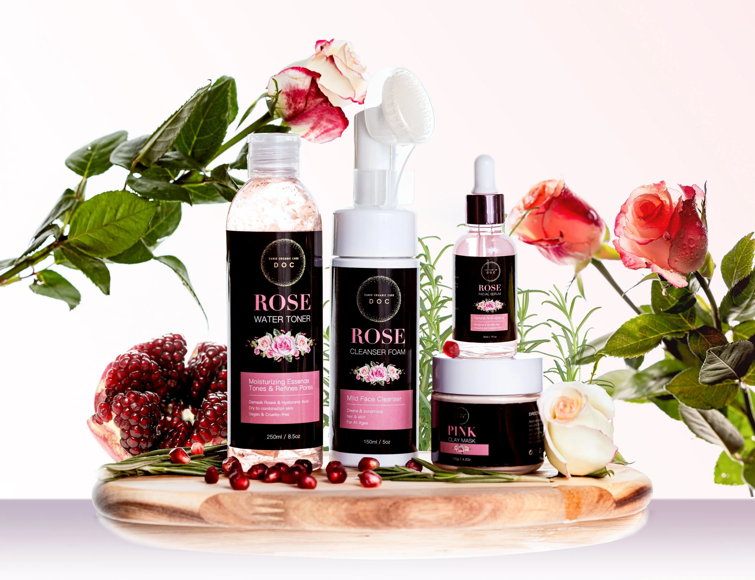 A collection of skincare products with rose and berry decorations on a wooden tray.