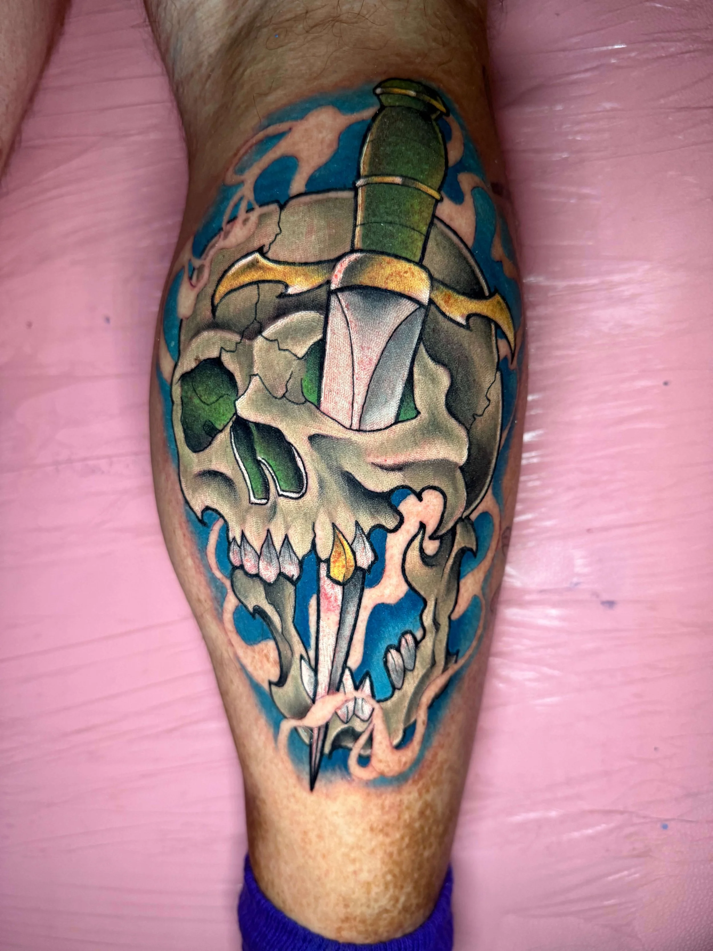 Neo traditional skull and dagger leg tattoo by Erin Peterson at Integrity Tattoo in Denton Texas.