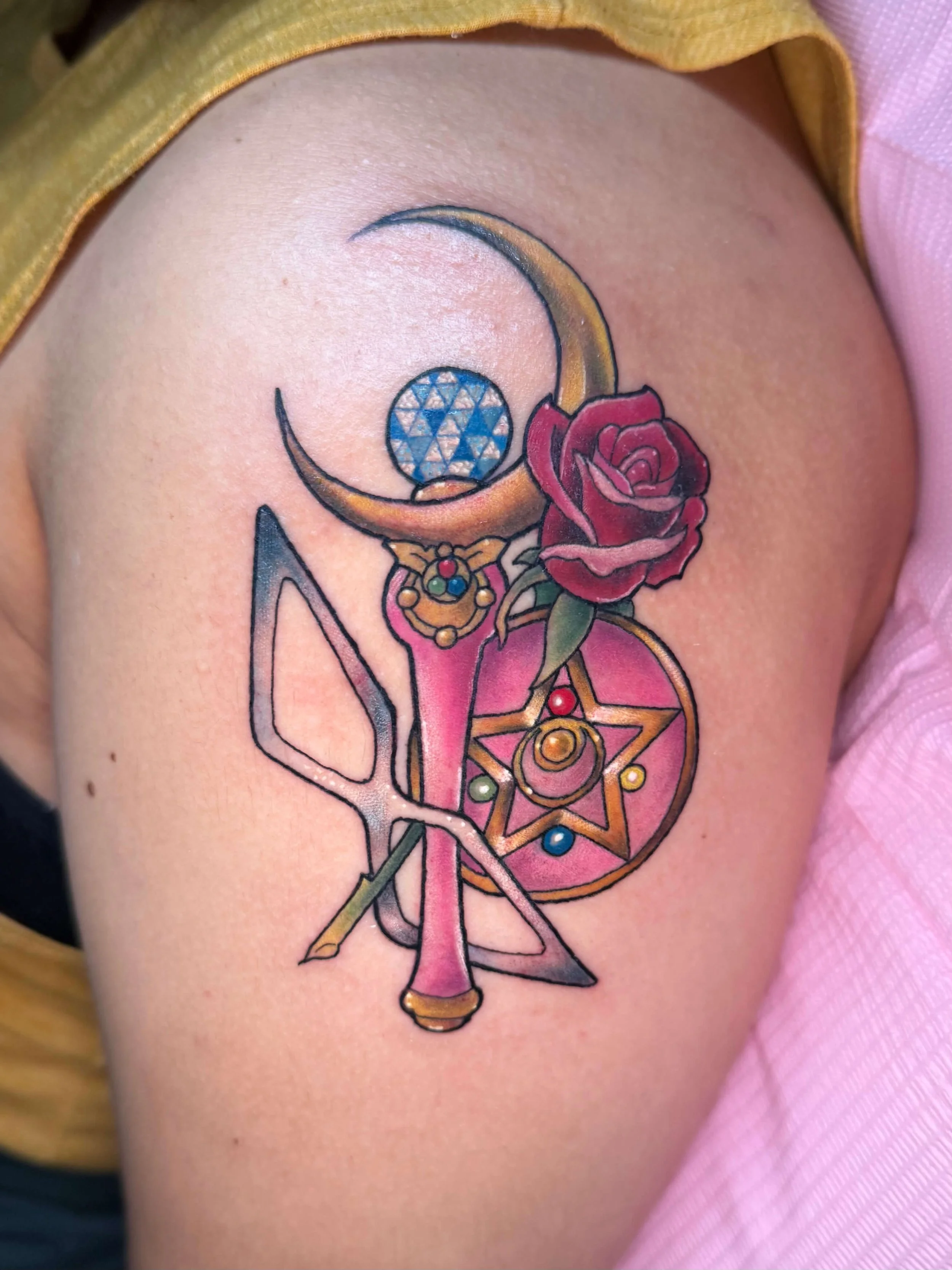 Sailor Moon shoulder tattoo by Erin Peterson at Integrity Tattoo in Denton Texas with moon wand and crystal star compact. 