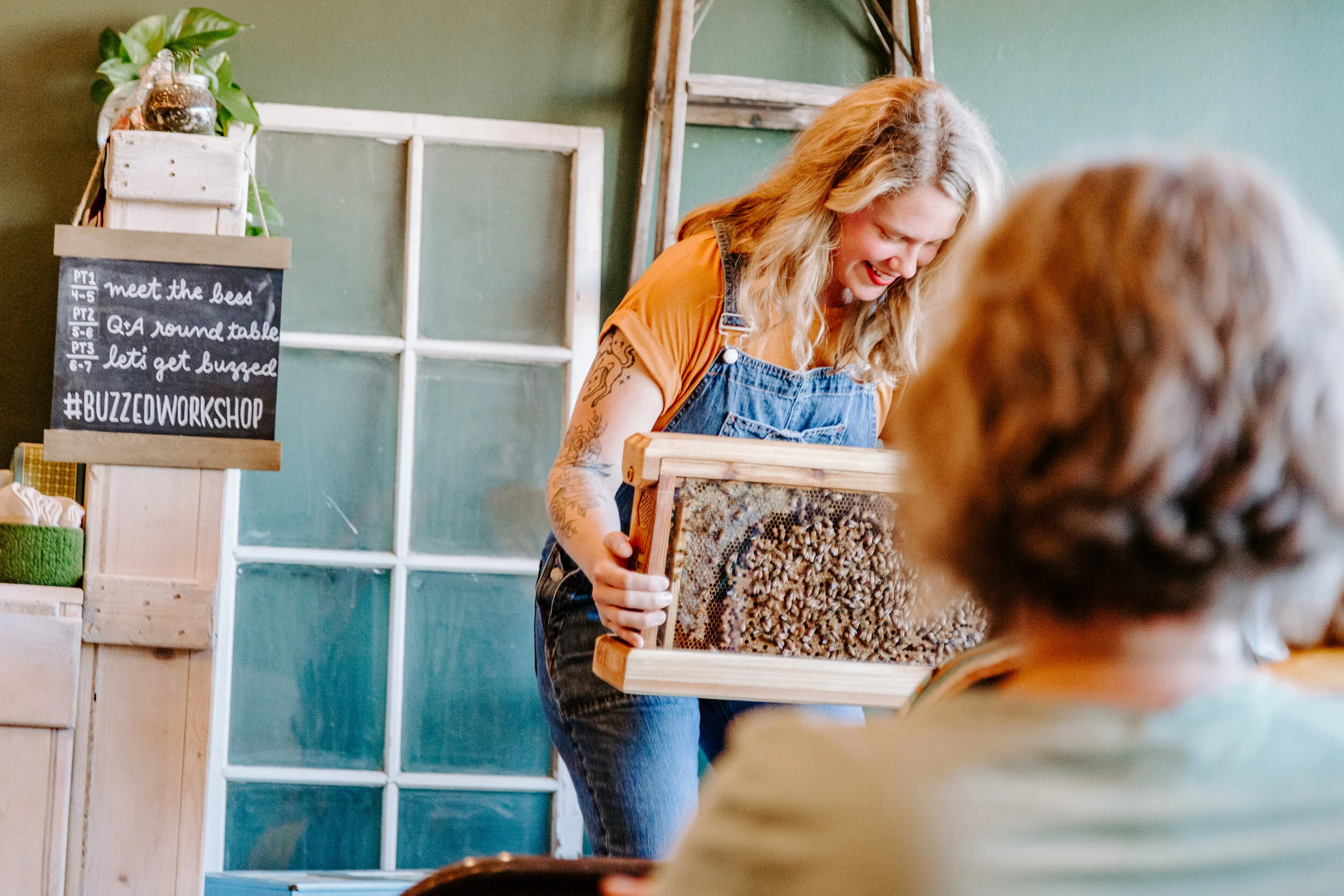 Christine Webster, founder and lead beekeeper of The Peoples Bees, presenting a live observation hive at an educational happy hour.