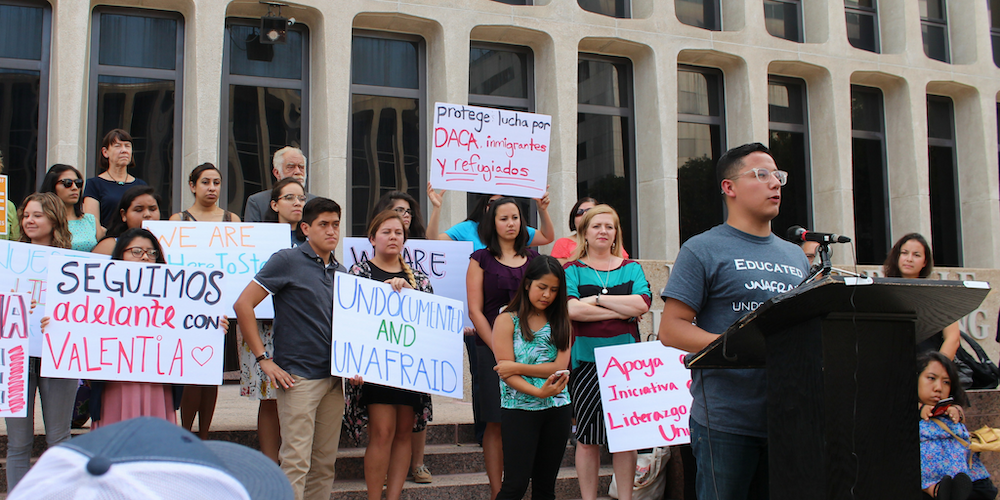 UT Austin student Samuel Cervantes speaks at a rally in downtown Austin against President Donald Trump’s order rescinding the Deferred Action for Childhood Arrivals program in September 2017. Attendees hold signs that say “Undocumented and Unafraid”…
