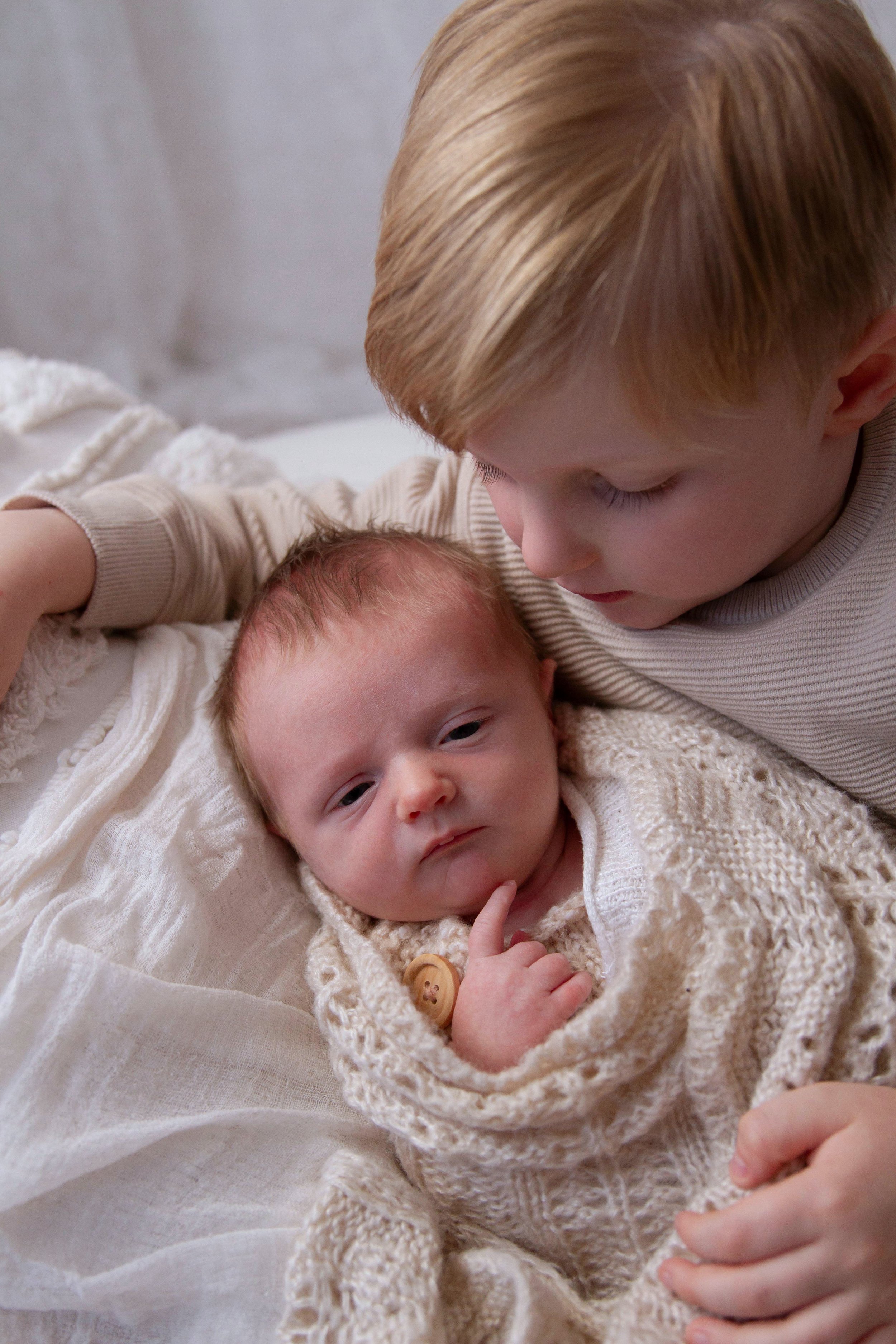 toddler looking at his gorgeous new brother