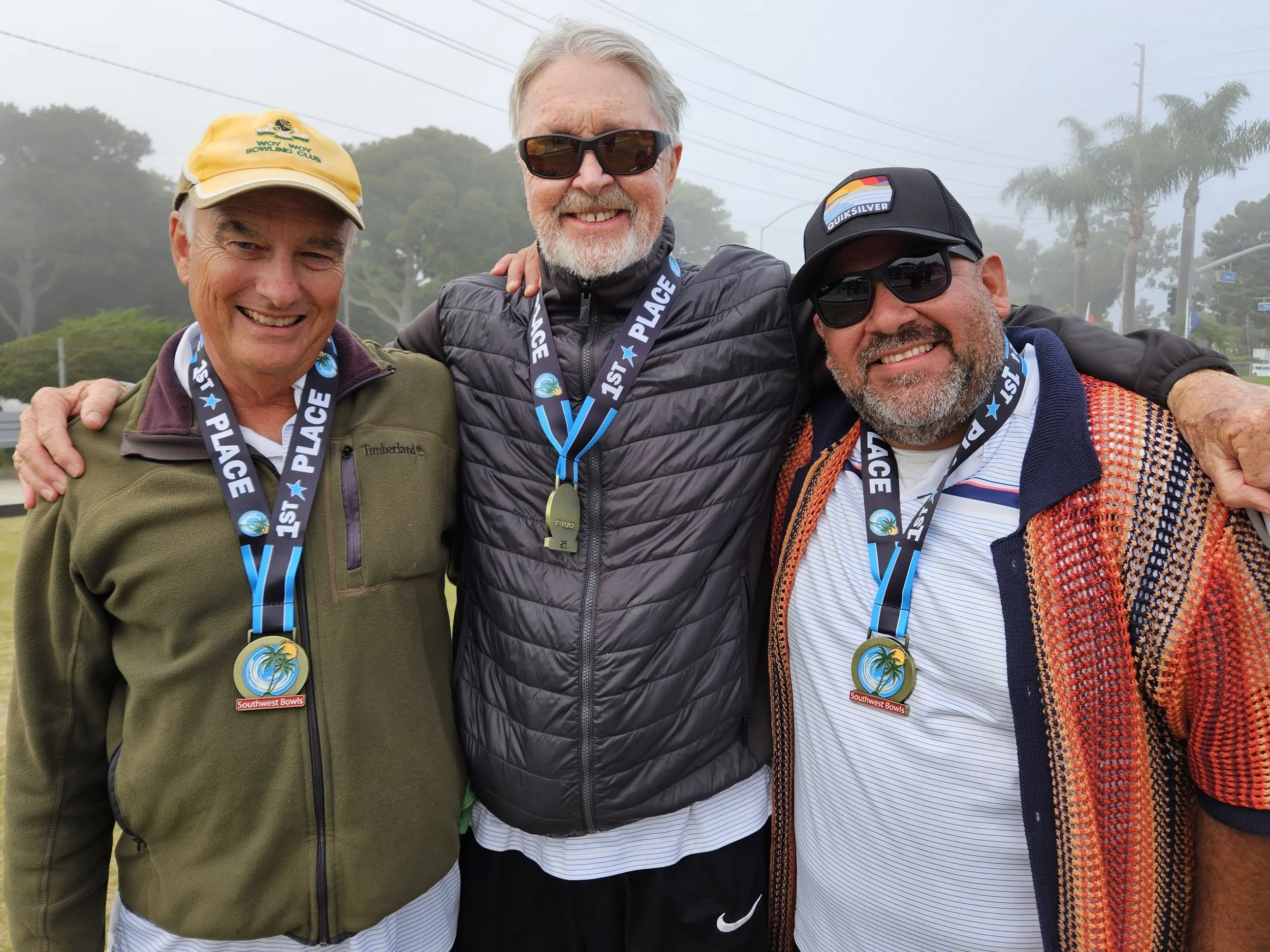 Three men wearing medals and