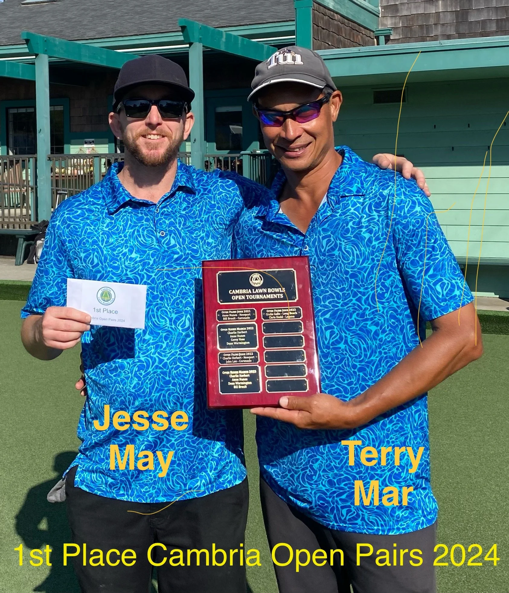 Two men in matching blue patterned shirts standing outdoors on grass, holding a plaque. One man holds a paper indicating first place. They are smiling, wearing sunglasses and hats, with a building in the background. The image caption reads, '1st Place Cambria Open Pairs 2024,' with the men's names, Jesse May and Terry Mar, displayed.