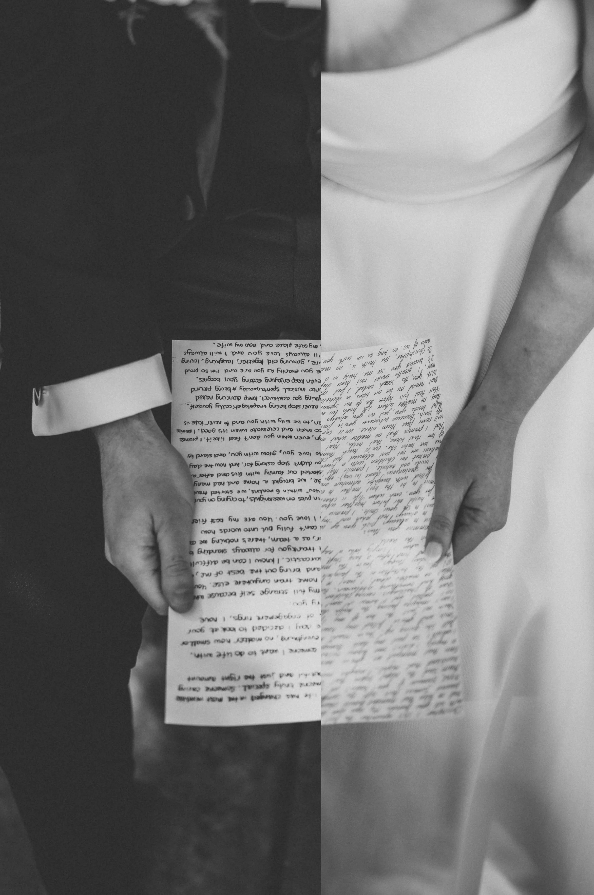 A person in formal attire holding a handwritten letter with both hands, the photo is in black and white.