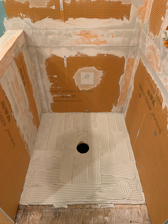 Simple adhesive to install the pan. Faster, cleaner and cheaper than old school hot mopping.