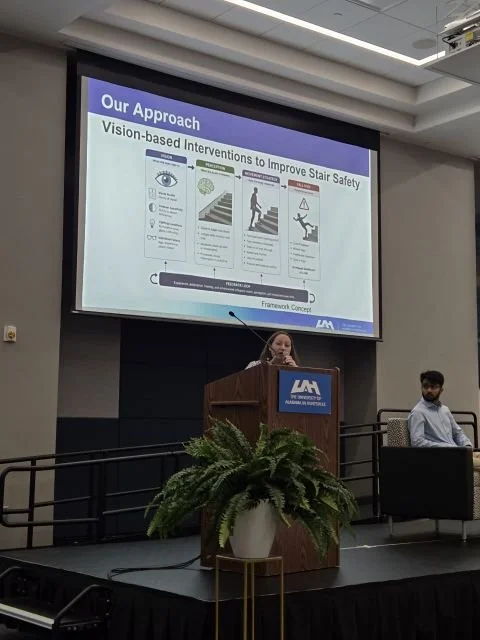 Dr. Sara Harper speaking at a lectern at the 2026 Slips, Trips and Falls International Conference, in front of a slide titled Vision-based Interventions to Improve Stair Safety.