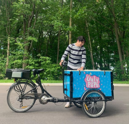Vendor selling popsicles out of a freezer