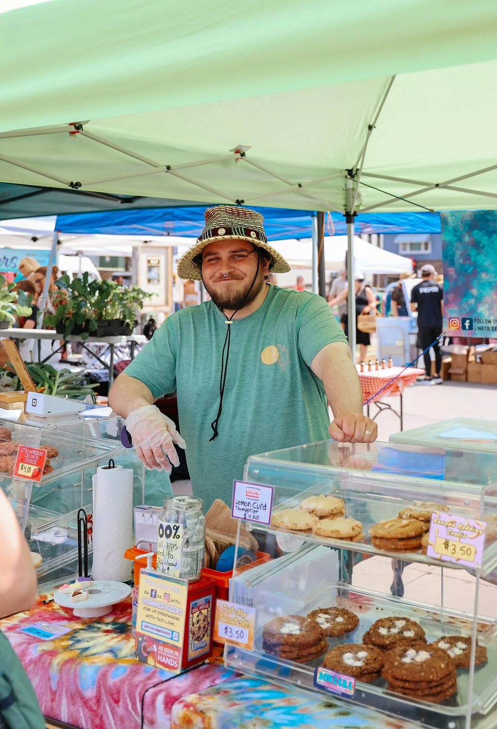 Vendor standing behind his booth selling cookies