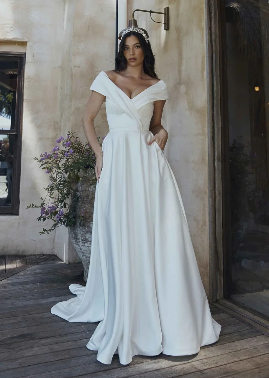 DIANA-TC2328-WEDDING-DRESS-VINTAGE-WHITE-SOFT-SATIN-OFF-SHOULDER-WRAP-BODICE-WITH-BUTTON-DETAILED-TRAIN-TANIA-OLSEN-BRIDAL-1.jpg.webp