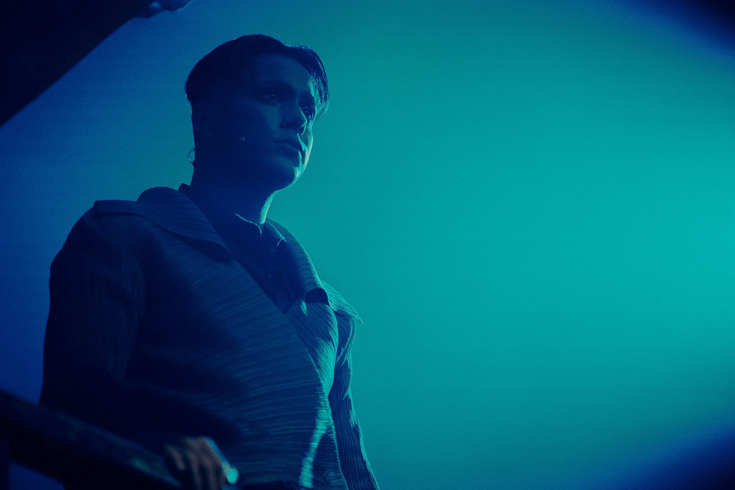 Silhouette of a person standing in blue lighting