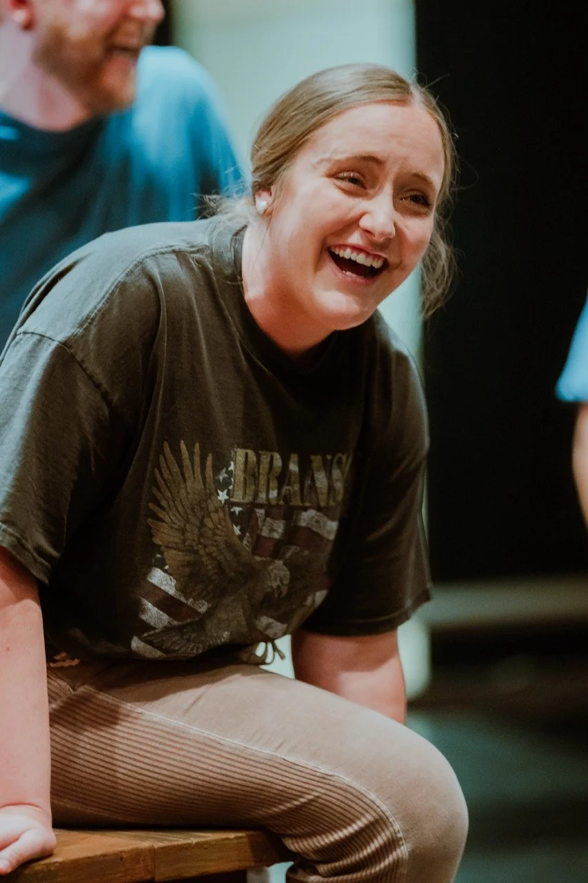 Smiling person in a casual setting wearing a Branson T-shirt