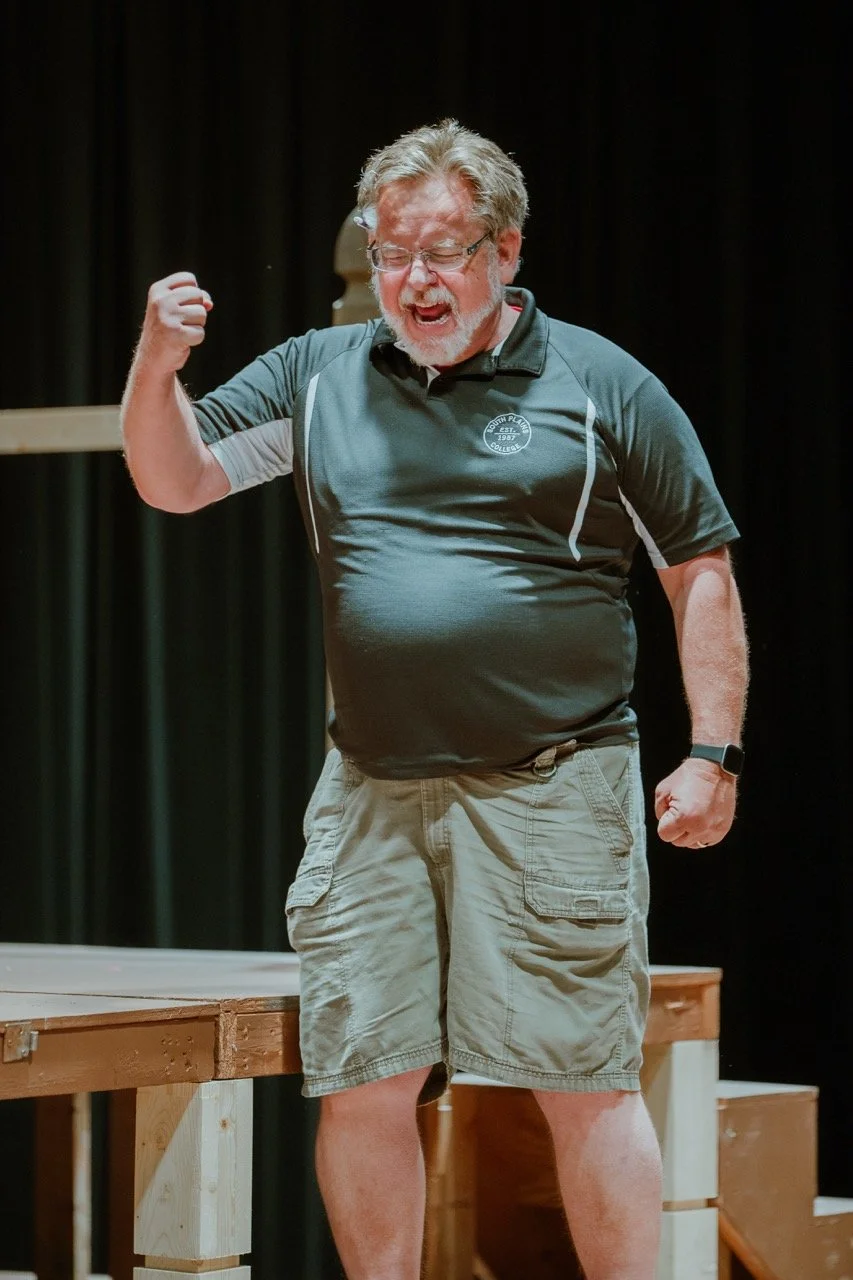 Man in casual clothing on stage expressing excitement