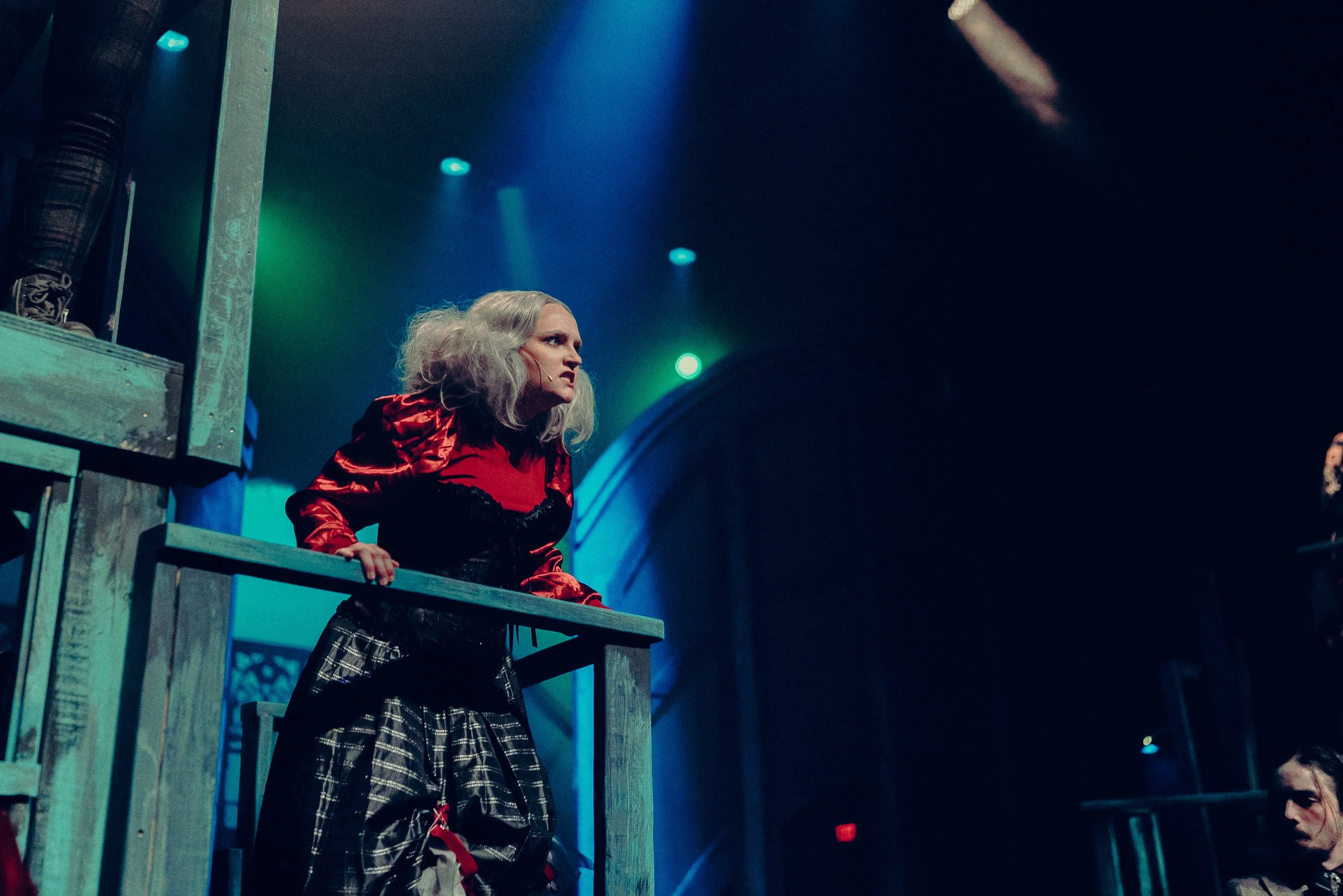 Theatrical scene with actor in costume on stage