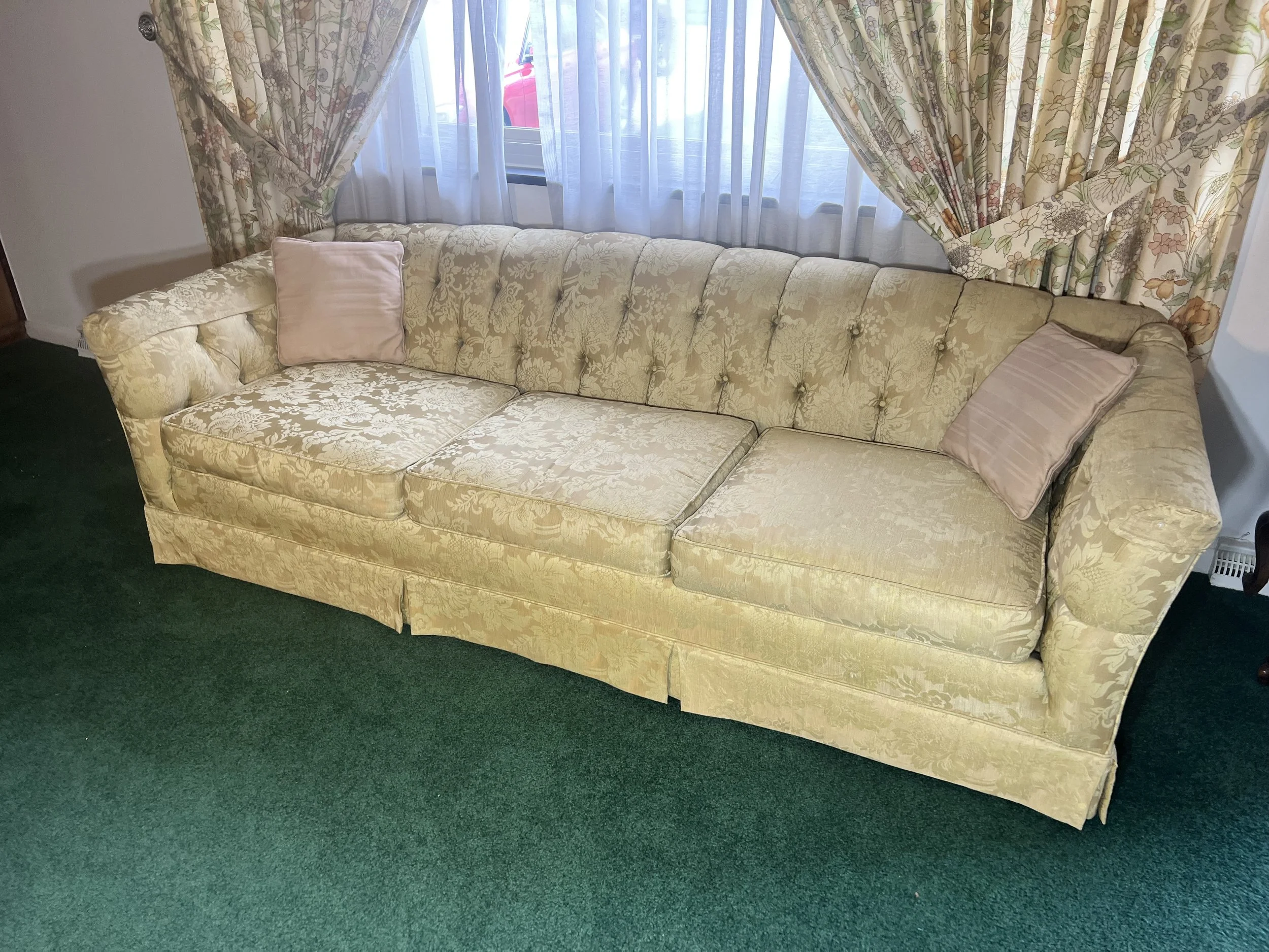 Luxurious Victorian-style tufted sofa in a shimmering champagne damask fabric