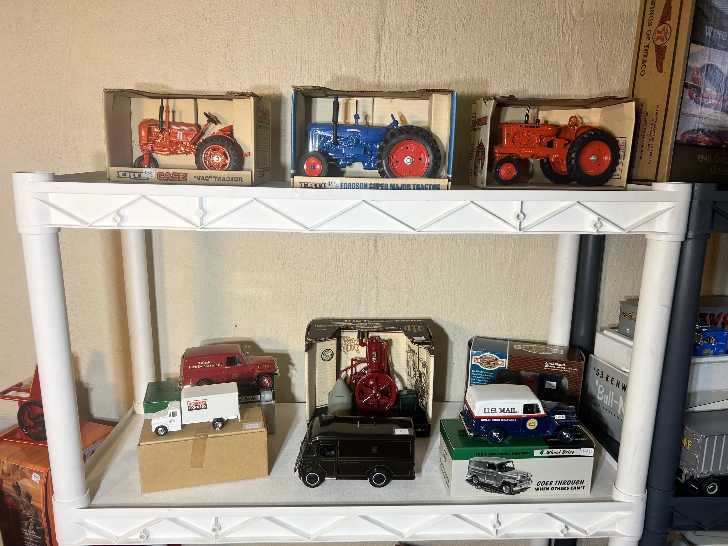 Vintage specialty vehicles including a Case tractor and a U.S. Mail Jeep