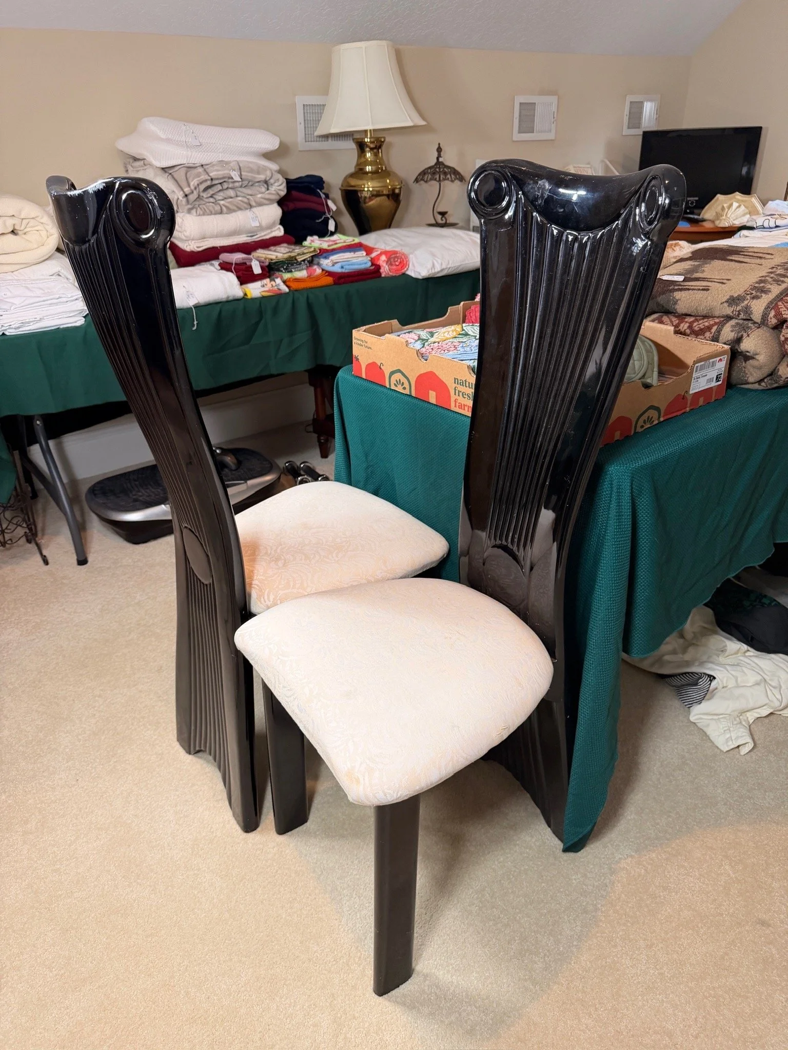 High-back black lacquered dining chairs with upholstered seats