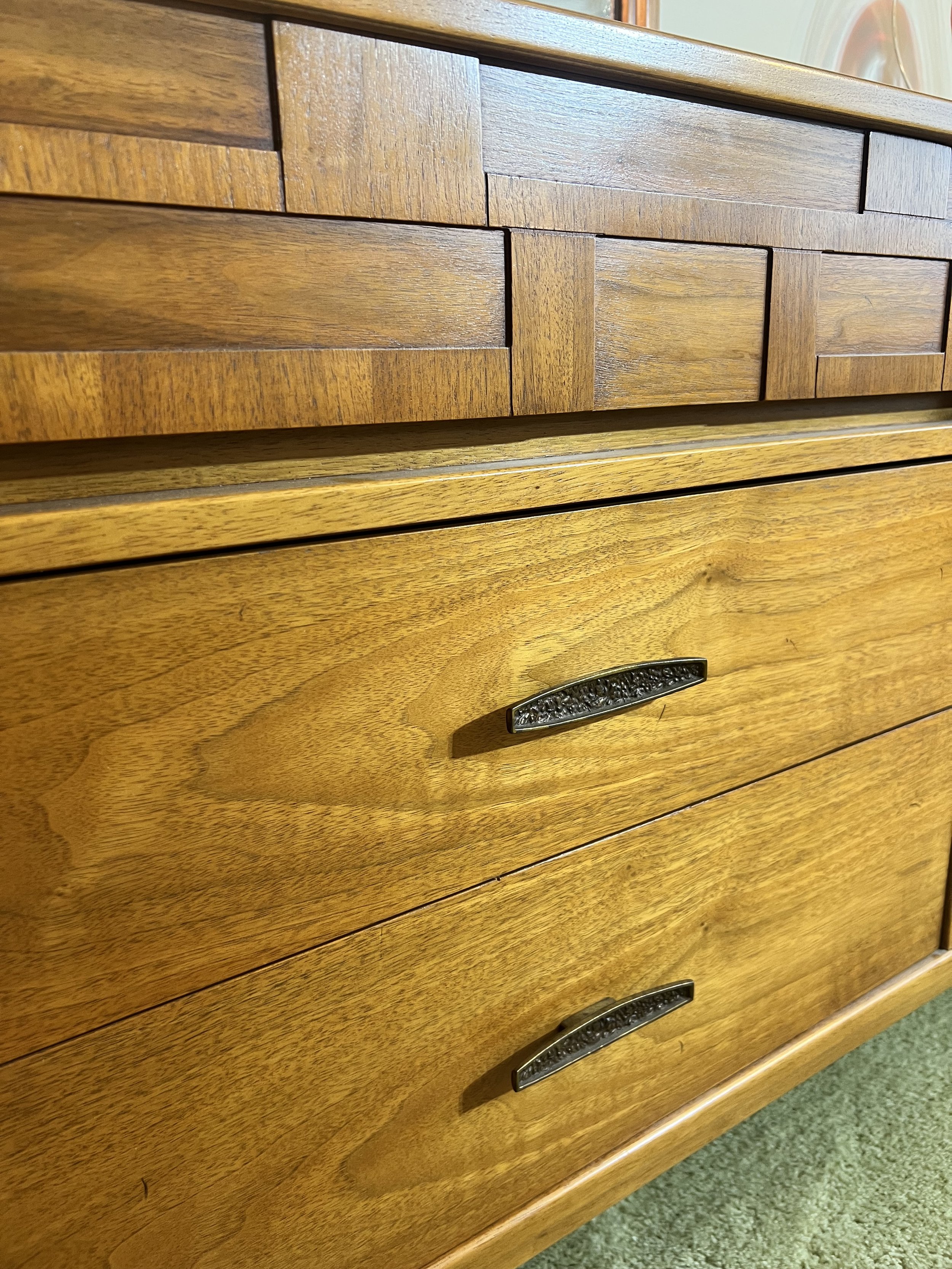 A stunning Mid-Century Modern double dresser featuring a distinctive woven wood facade on the top drawers and original brutalist-style hardware