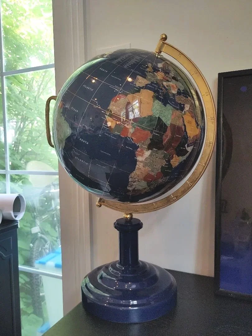 Heavy, hand-crafted luxury tabletop globe featuring deep lapis lazuli oceans and semi-precious gemstone country inlays