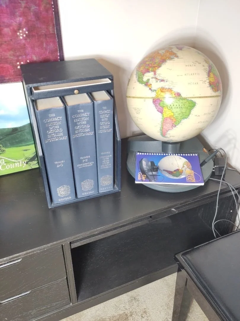 The Compact Edition of the Oxford English Dictionary with its magnifying glass drawer and Odyssey Atlasosphere