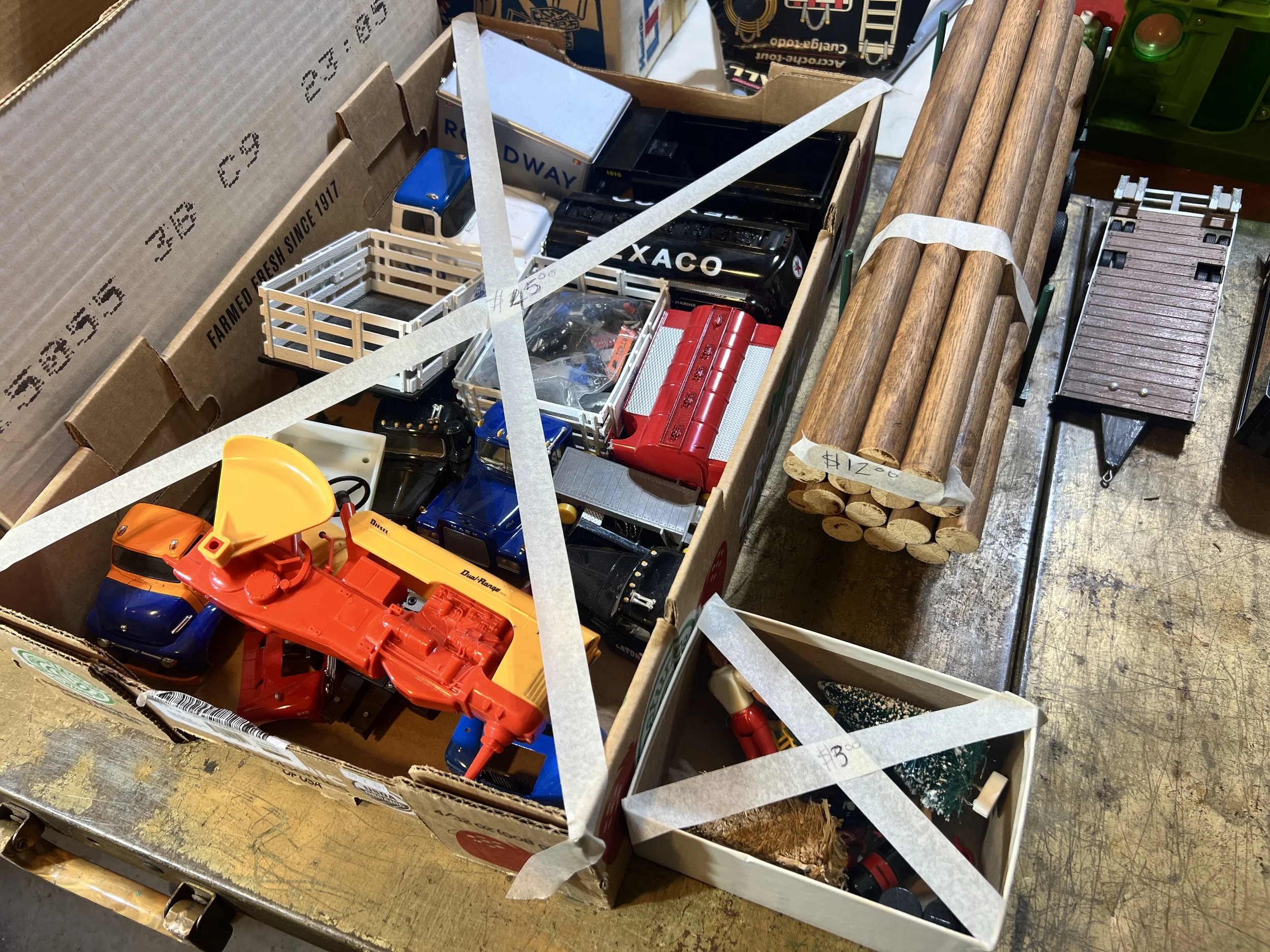 Box of Texaco and Roadway trucks, vintage wooden logs