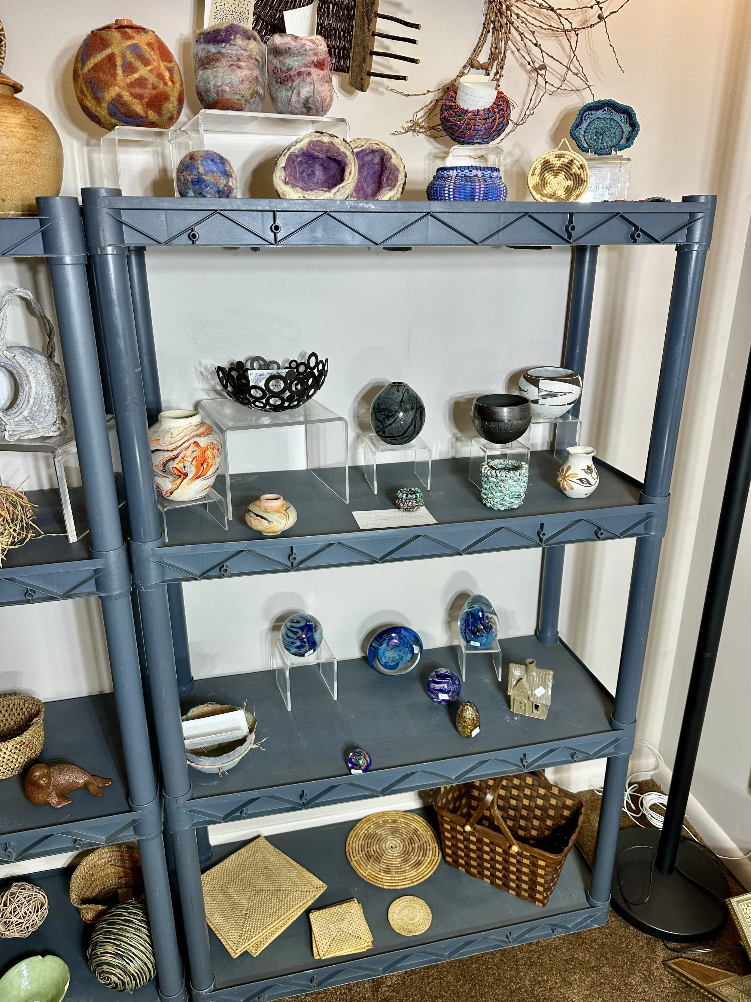 Various decorative baskets, felt artwork, and other artwork