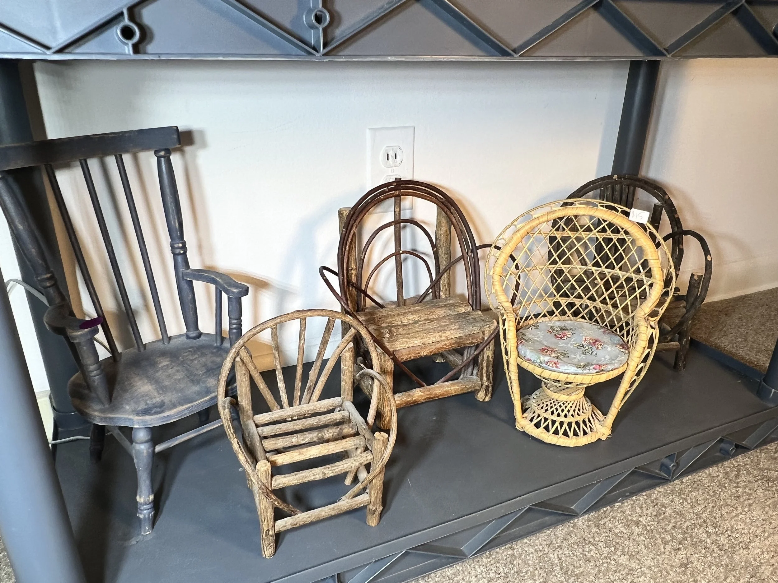 A charming collection of doll-sized furniture including wicker and Adirondack styles