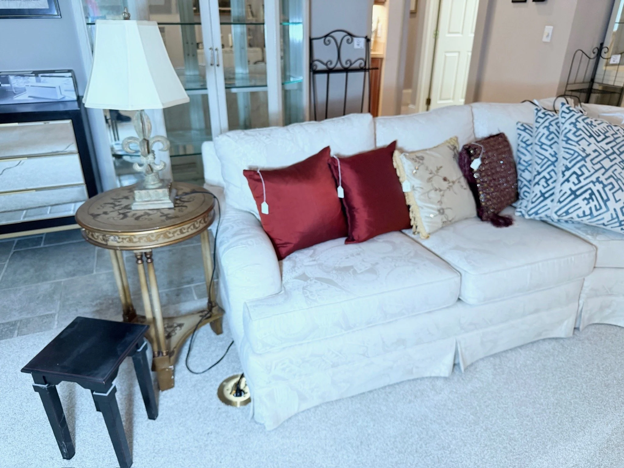 Large white multi-piece living room sectional sofa, multiple options of accent pillows, side tables