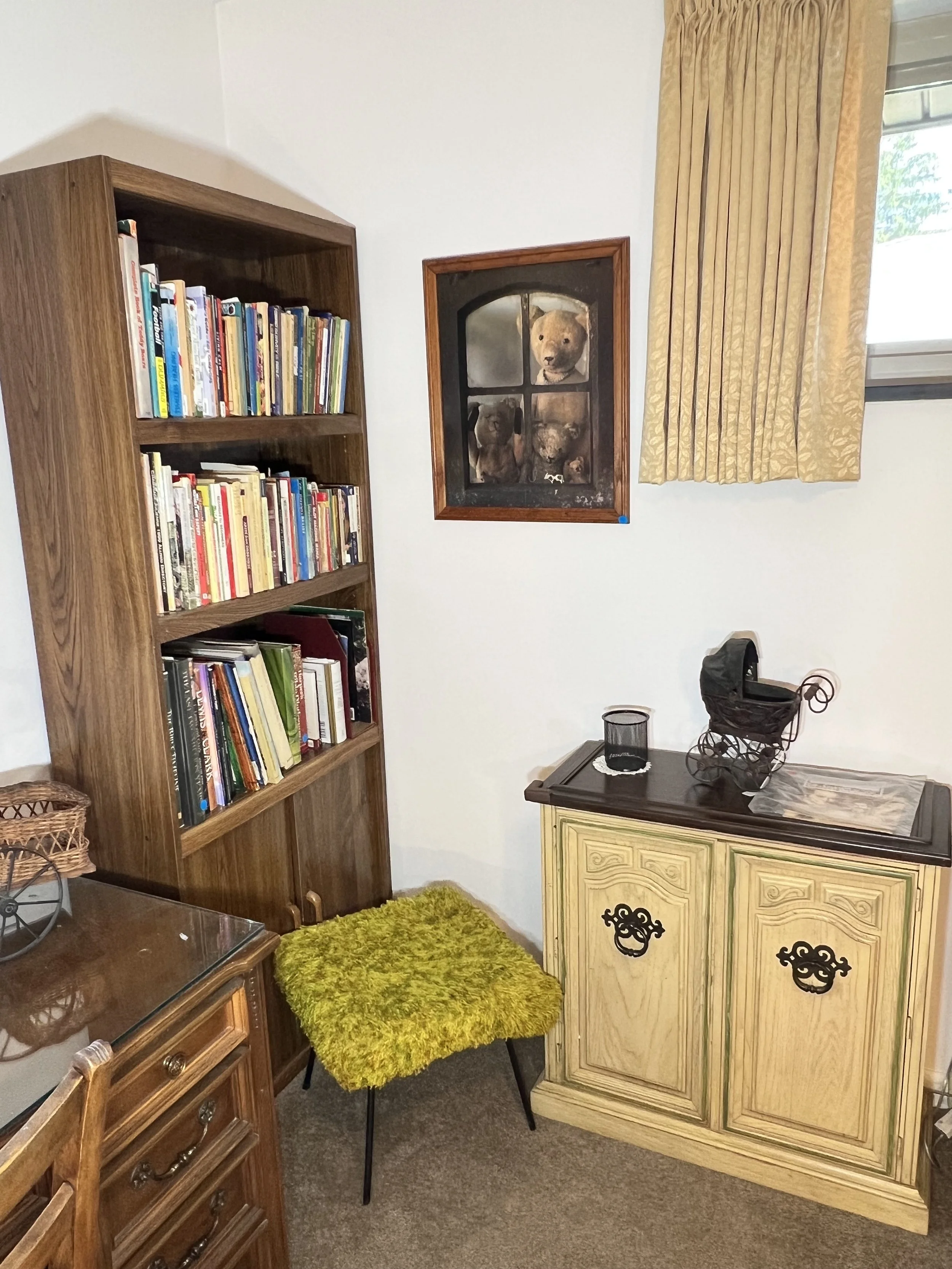 Cozy office corner featuring a walnut-finish bookcase and a French Provincial accent cabinet