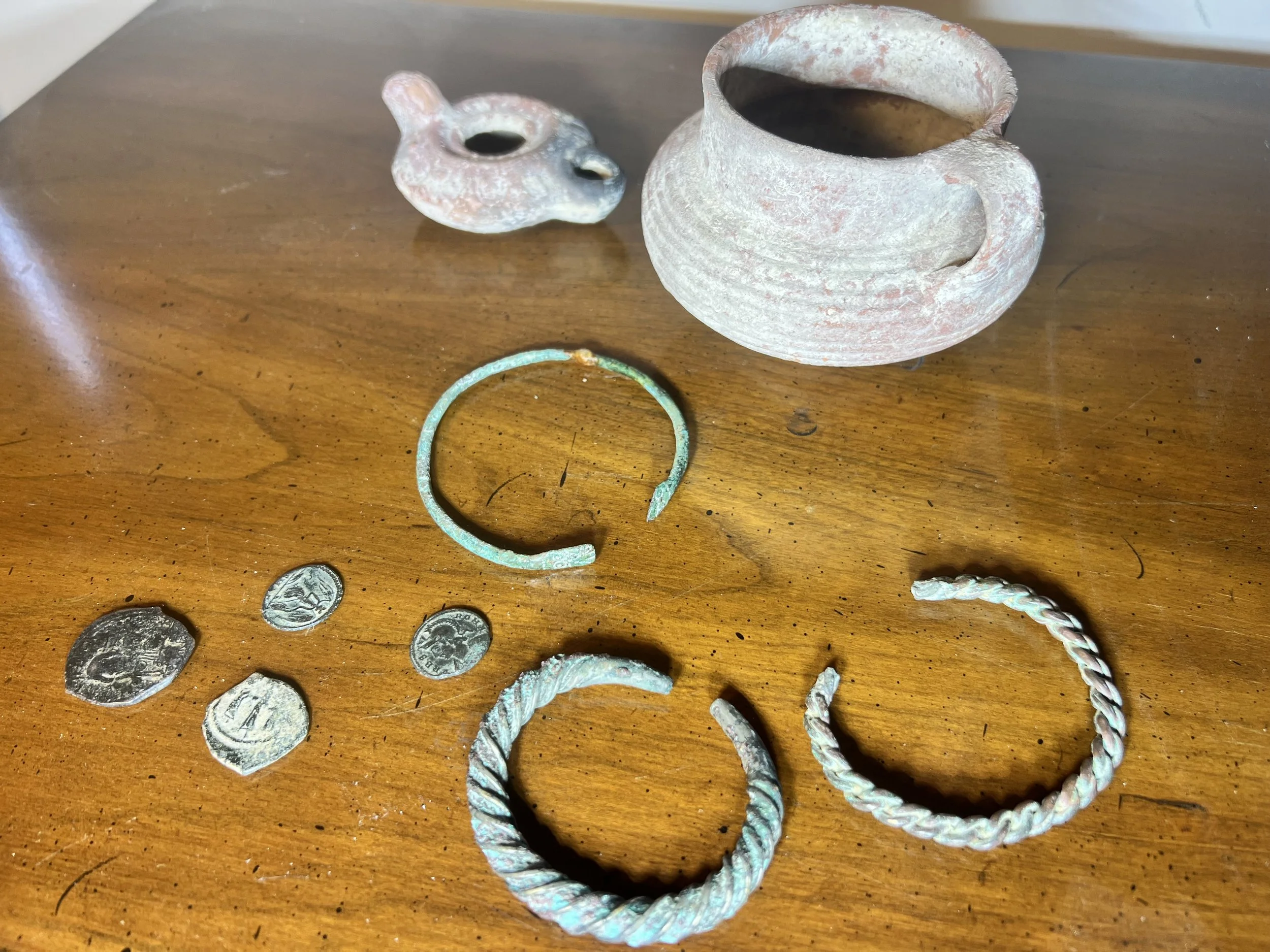 Incredible collection of ancient artifacts including bronze torques, coins, and a clay oil lamp
