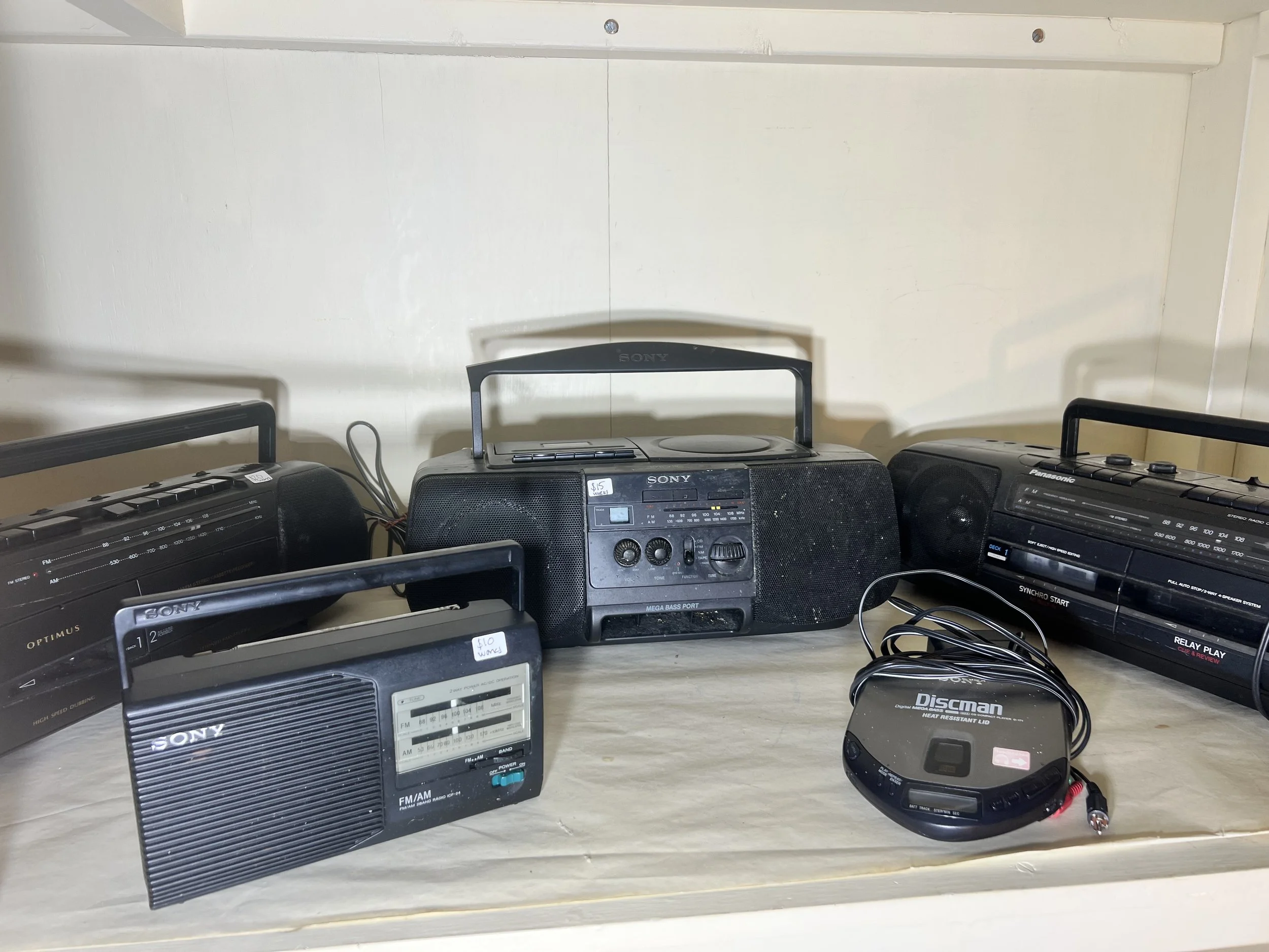 Vintage electronics including a Philips Blu-Ray player and various Sony portable audio devices