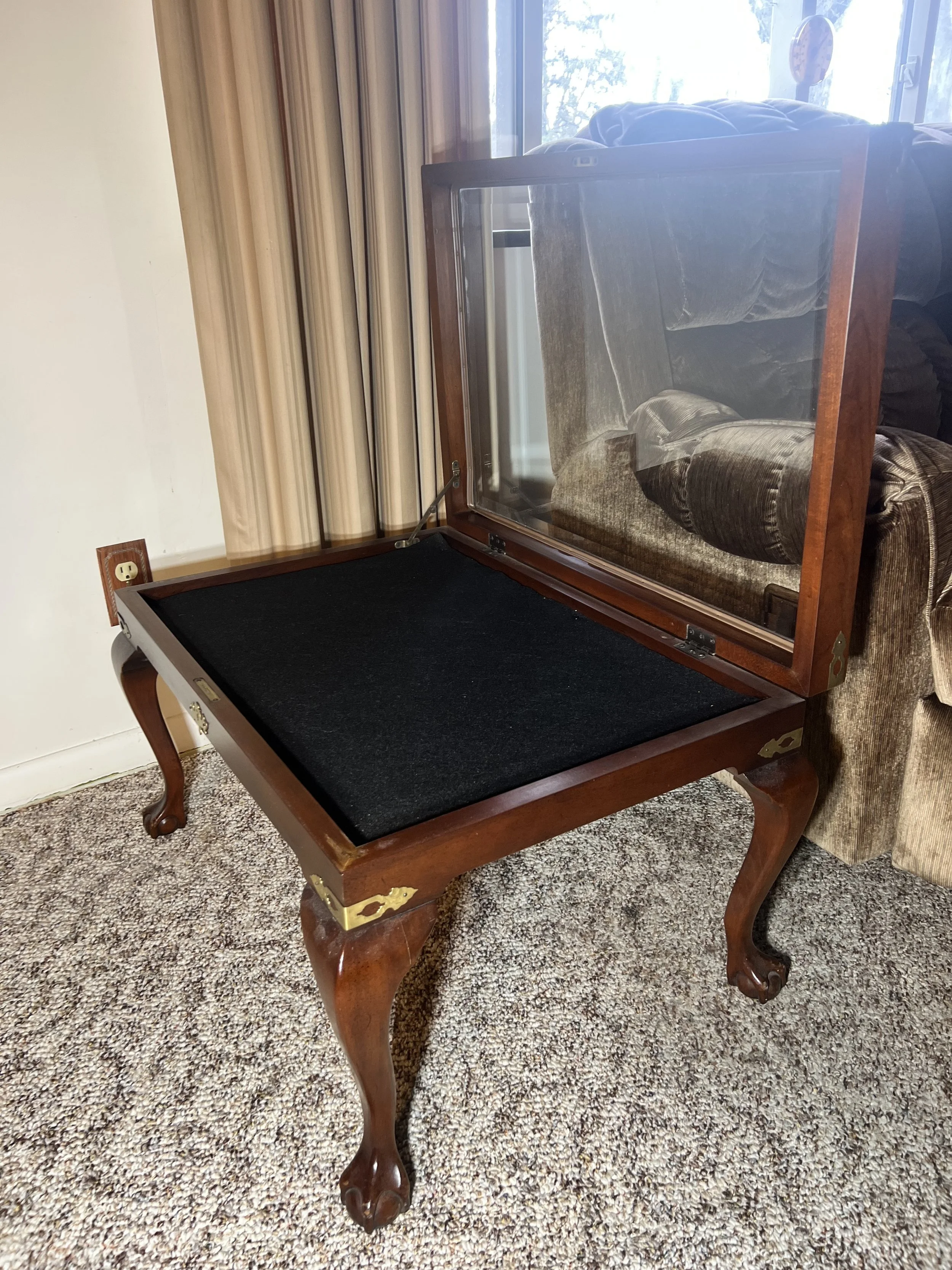 Sleek Mission-style sofa table with glass-top panels and a center storage drawer