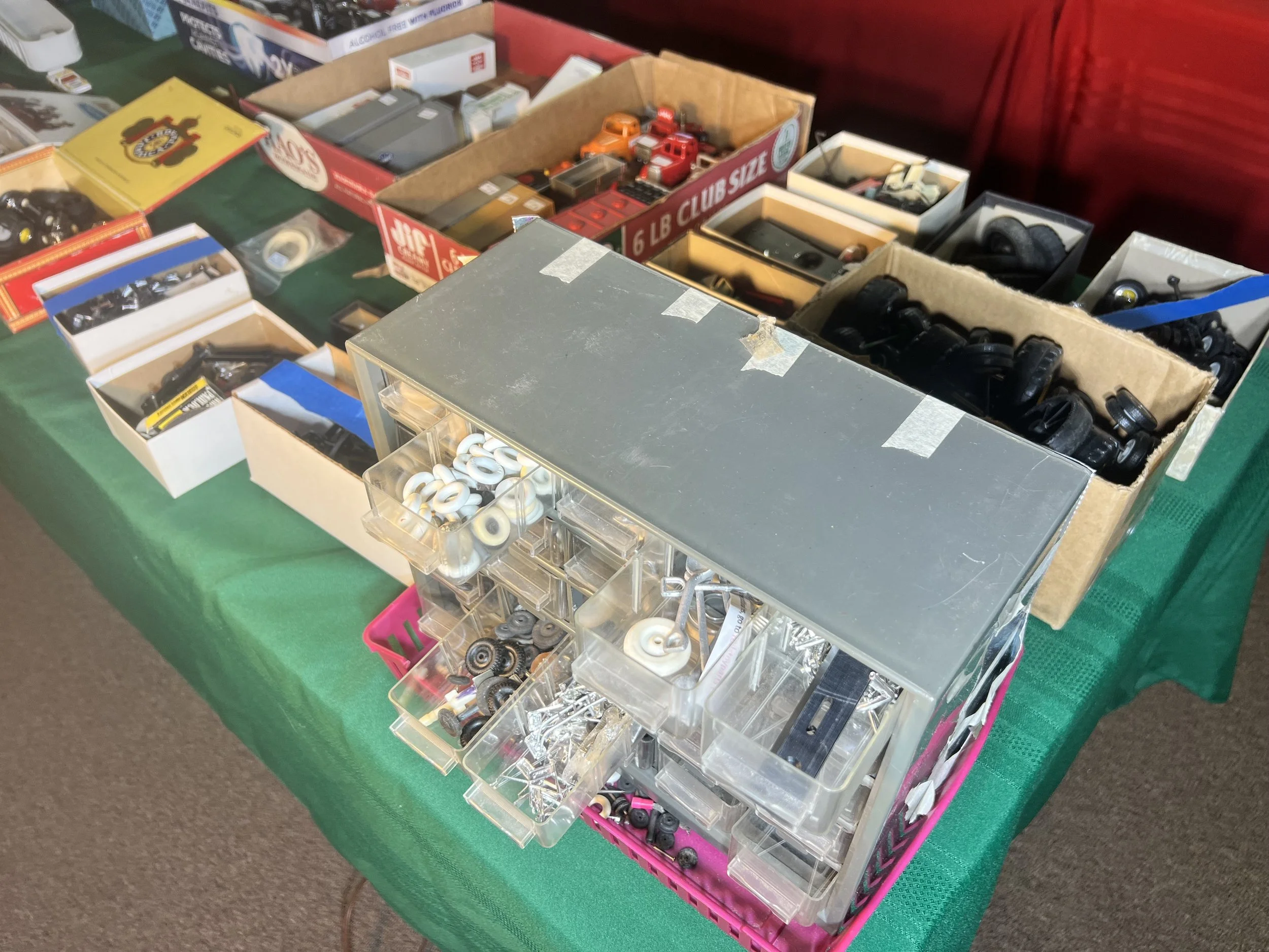 Multi-drawer parts organizer filled with vintage die-cast restoration components