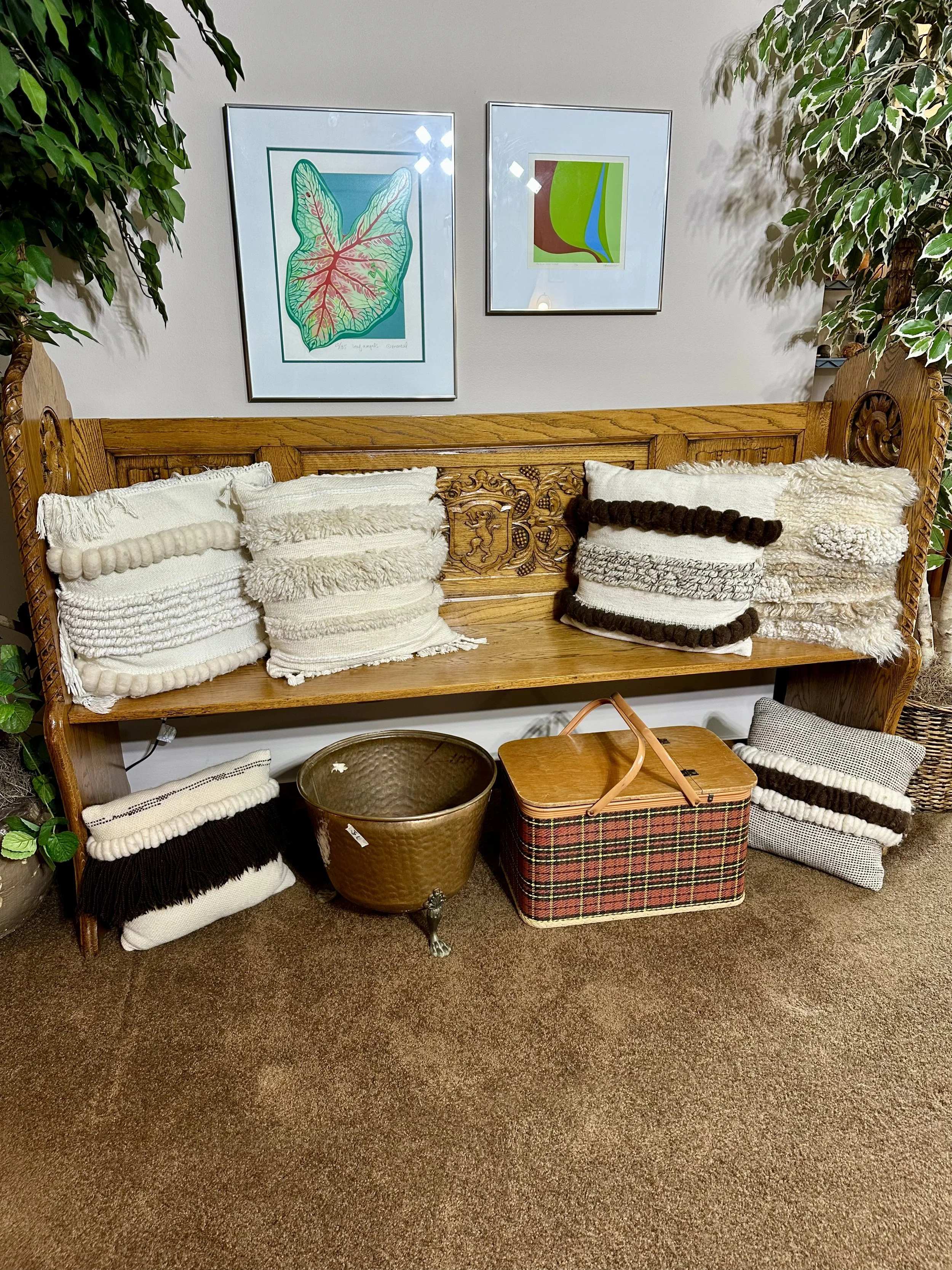 Antique church pew, decorative pillows, framed art