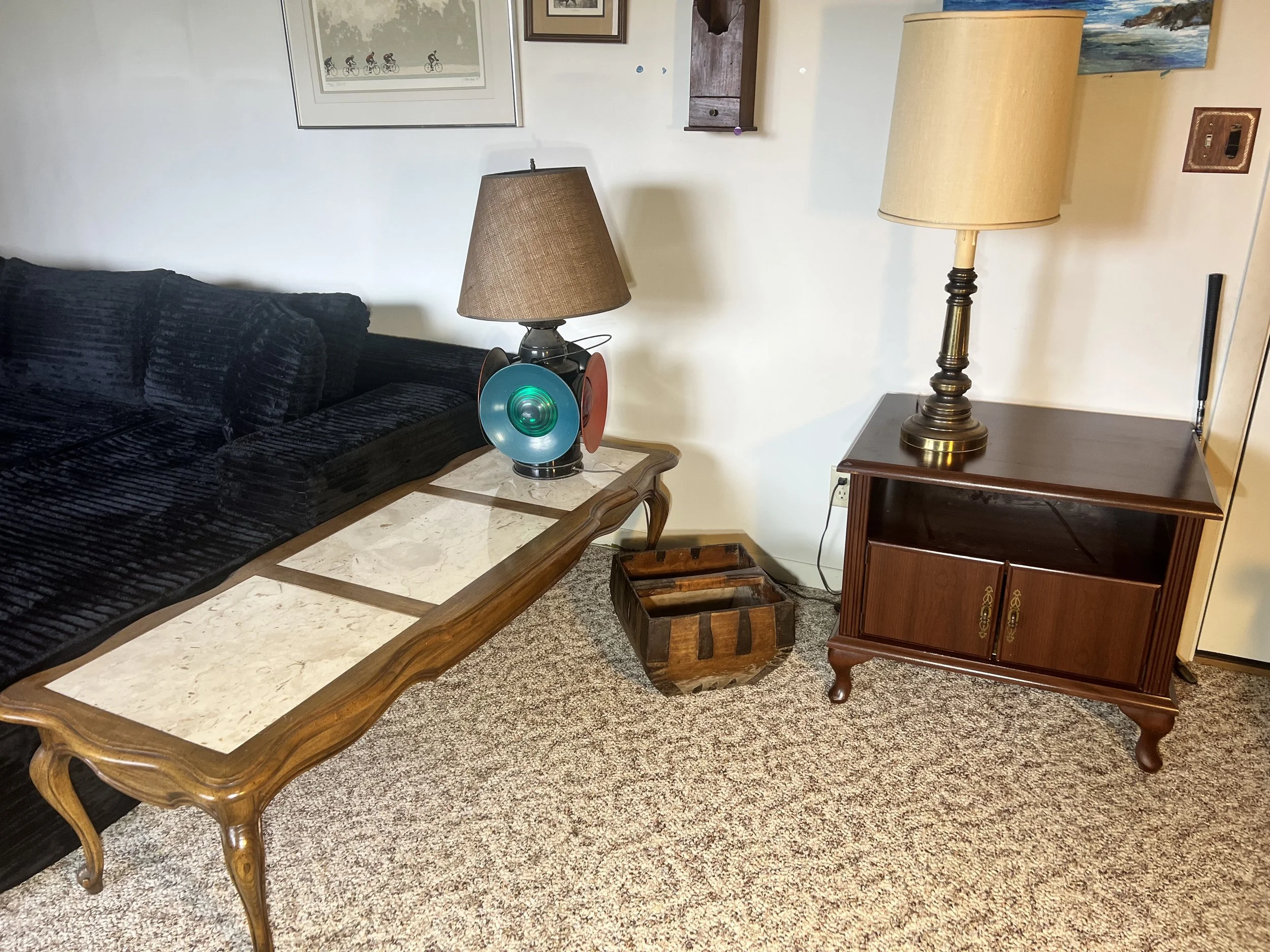Long wood-framed coffee table with three inset marble panels and elegant cabriole legs