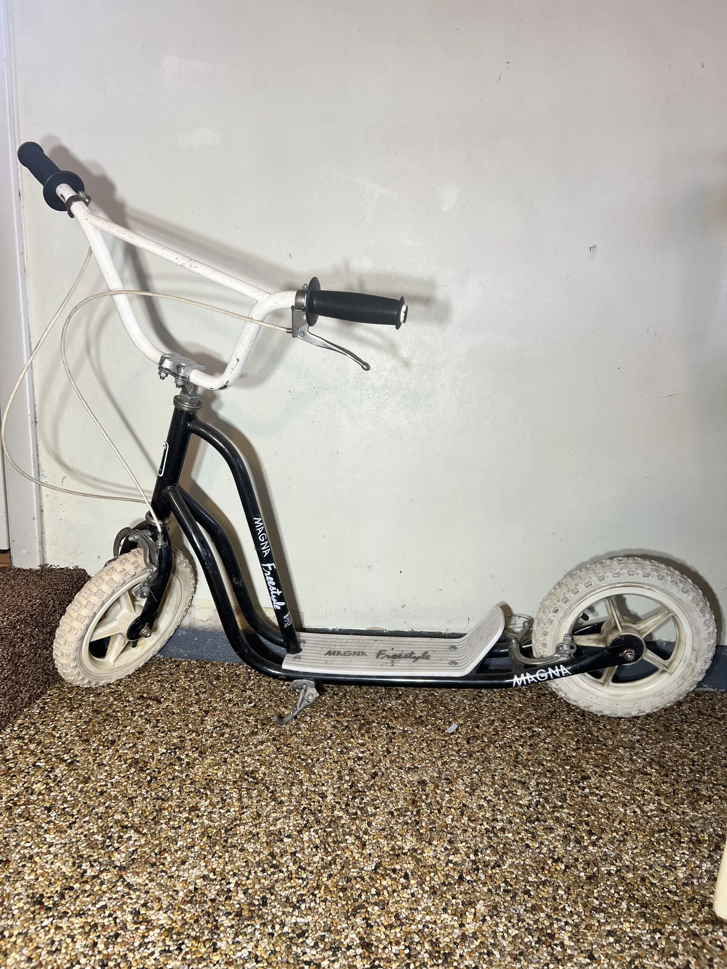 Magna Freestyle black and white scooter with rugged pneumatic tires