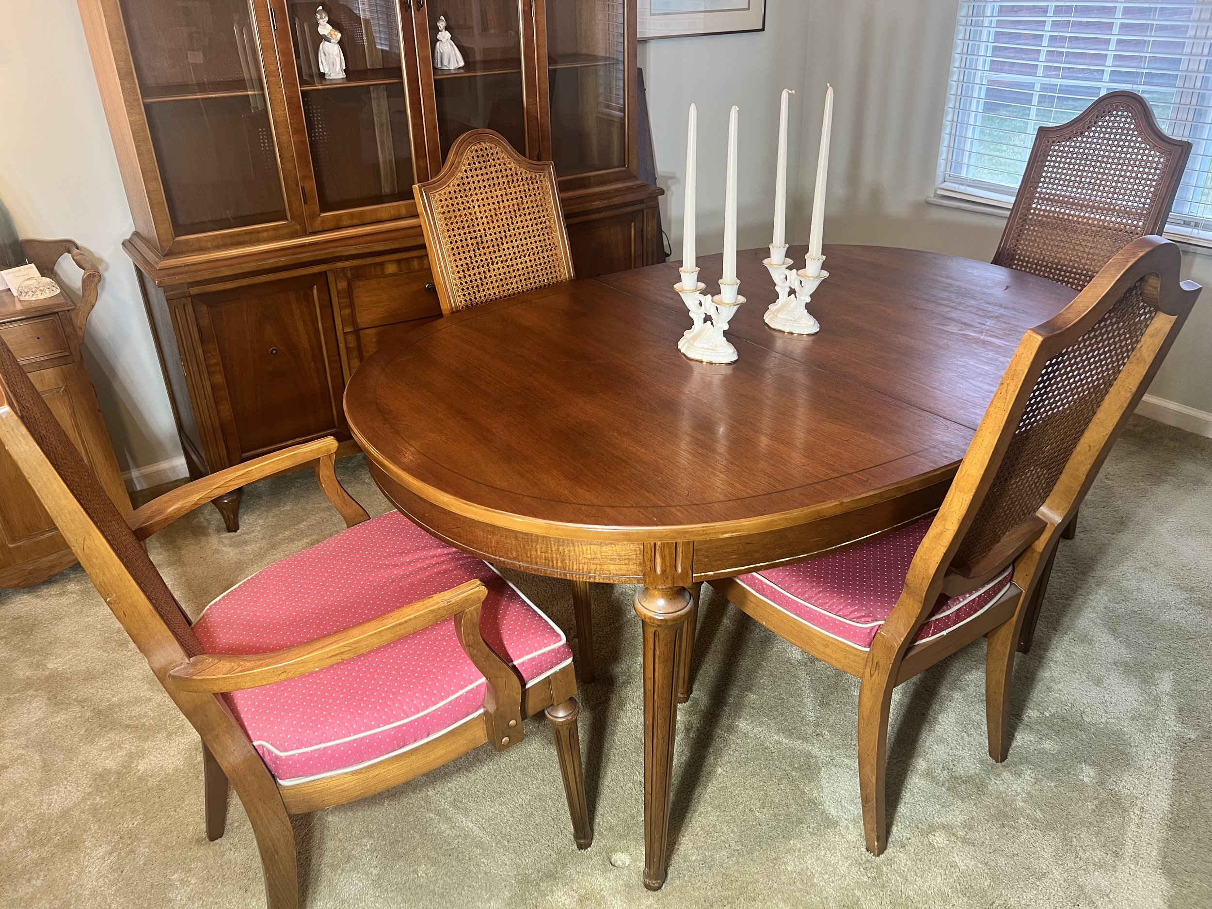 Formal Dining Set: Oval wood dining table with leaf and set of cane-back chairs with pink upholstered seats