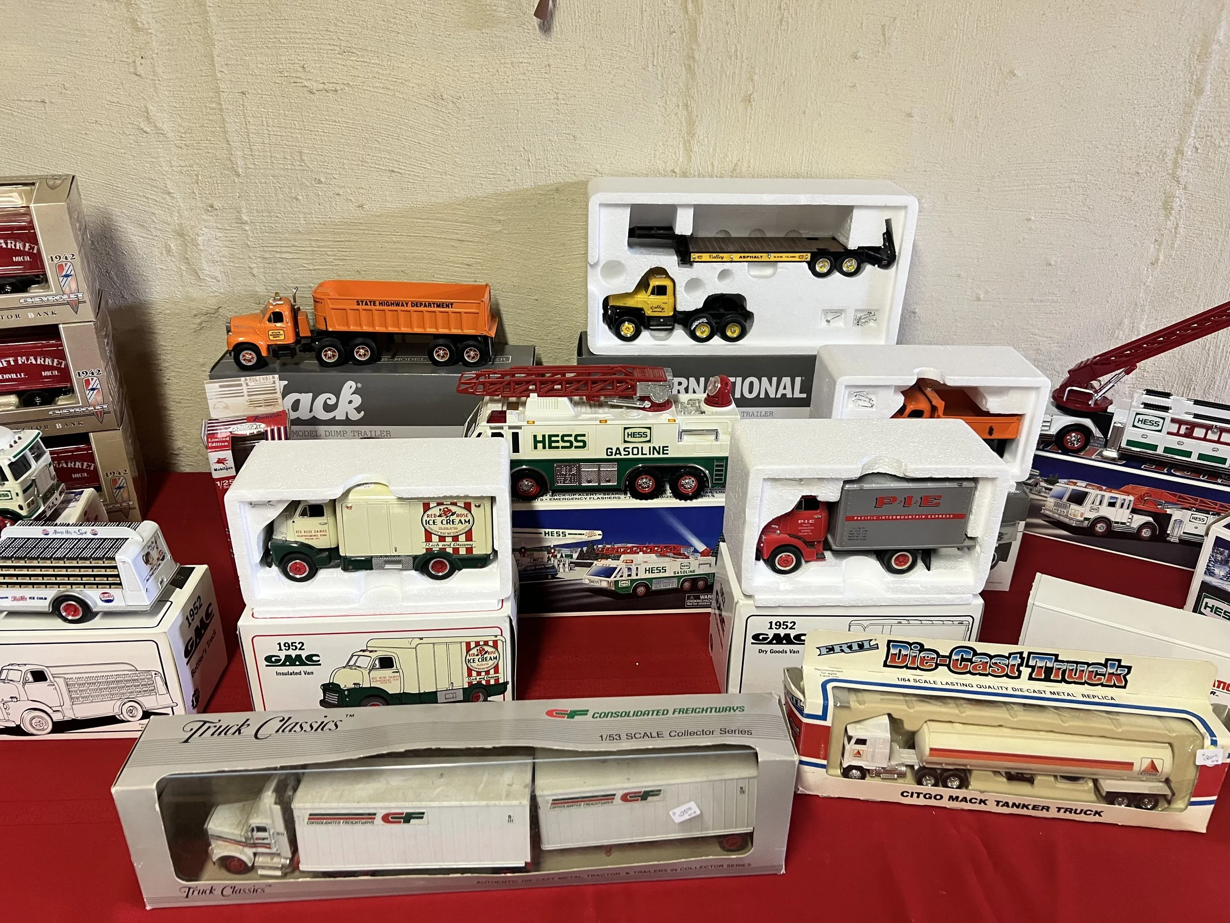 Professional Grade Replicas – Exceptional GMC, Mack, and International die-cast trucks, including a detailed 1952 GMC Insulated Van and state-highway department dump trailers